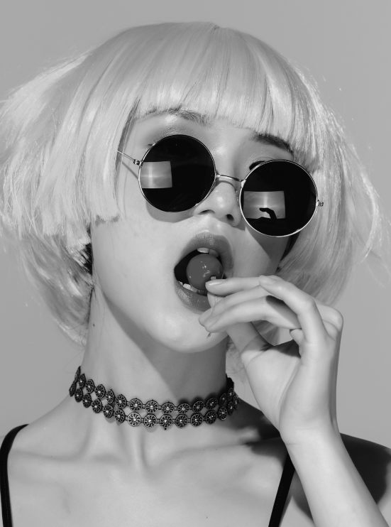 asian lady tasting a lollipop bw
