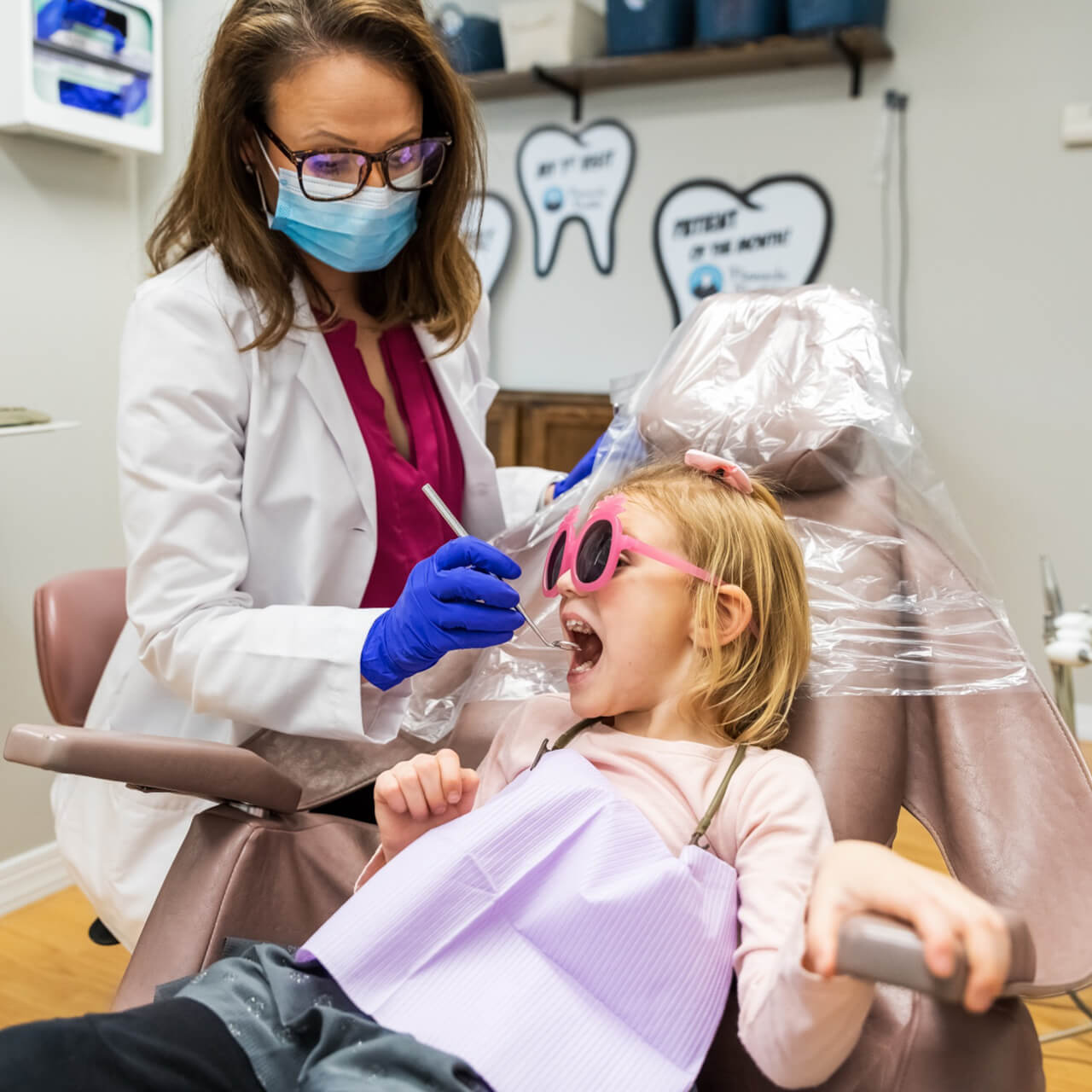 Dr. Megan cleaning a child's teeth during an annual checkup