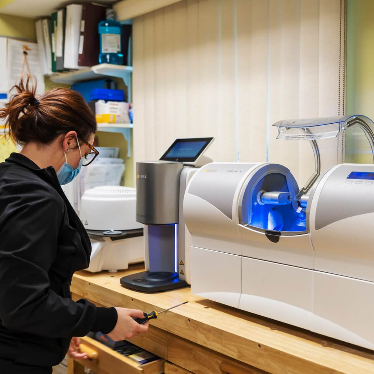 Dr. Megan Kottman showing the CEREC® one day crown machine in the dental office.