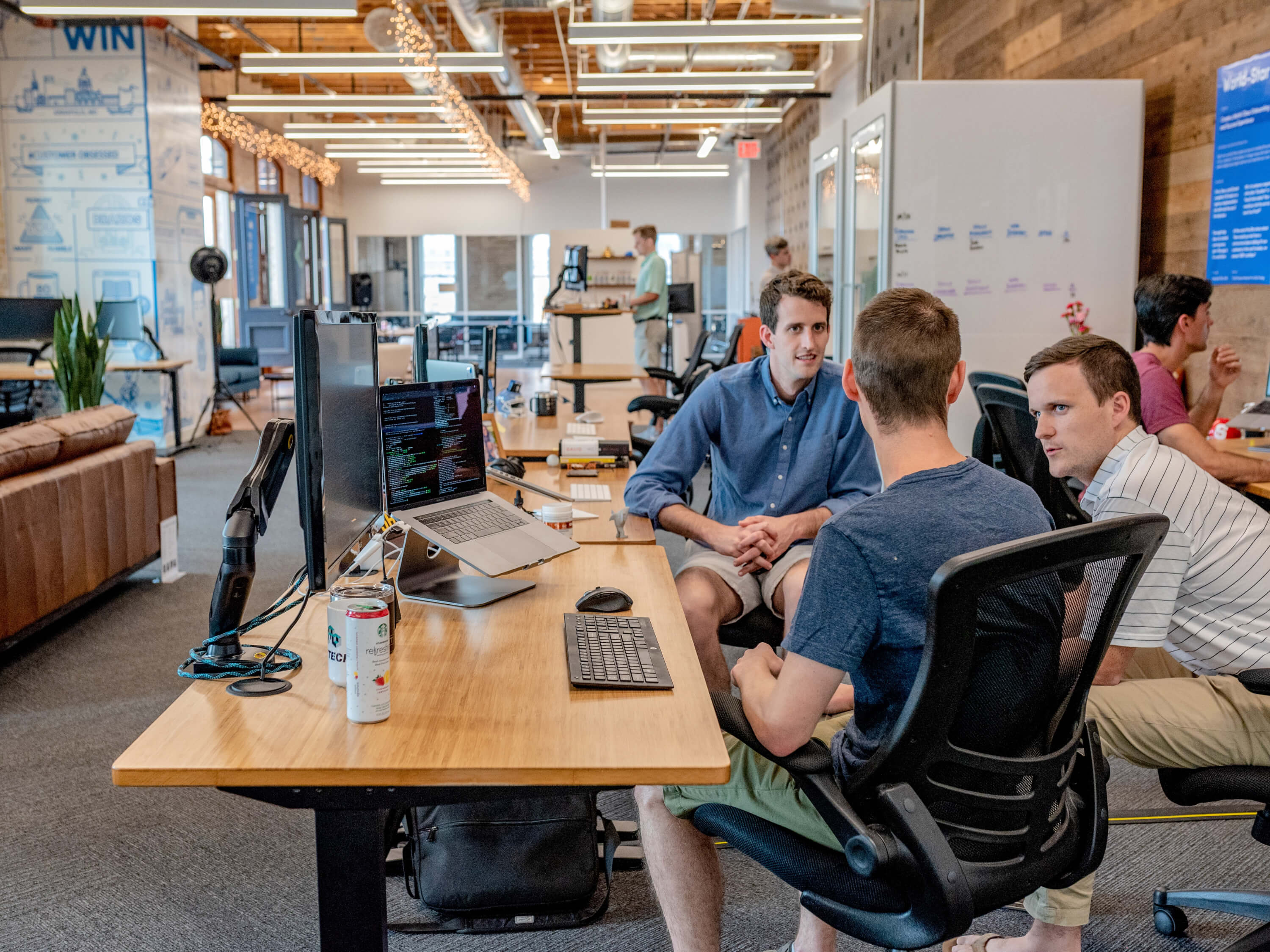 Three software developers talking in an office