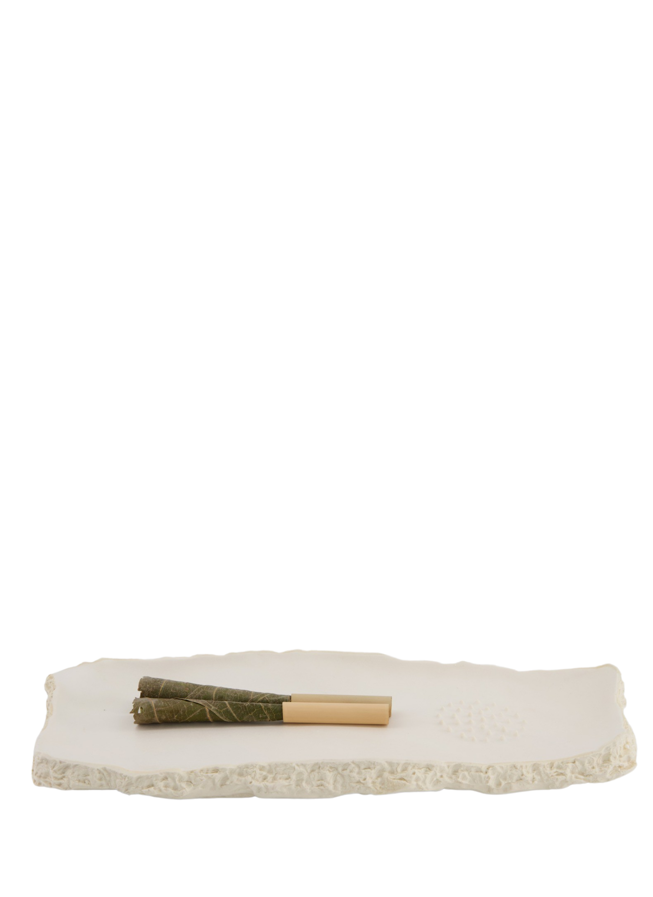 Molded from a real piece of maple from Toronto's High Park, the matte-glazed ceramic rolling tray uses locally sourced clay from Alberta and Ontario. Made by hand in small batches in Toronto and packaged in 100% Recycled paper, it's a tray that couldn't possibly leave you with buyers' remorse. The interior of the tray has a matte glazed finish and features a built-in grinder and pouring spout. The raw underside of the tray honors the integrity of the tree itself.