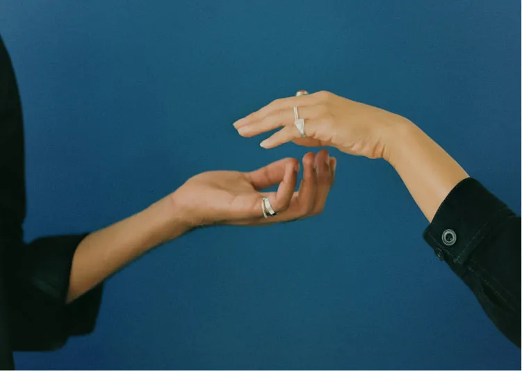 Two hands reach out for each other