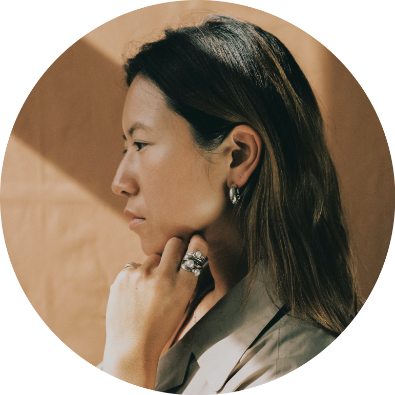 A woman looks thoughtfully over her shoulder