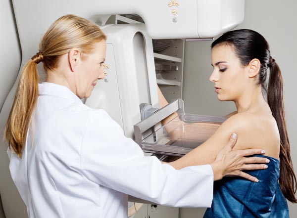 Female Doctor is preparing a woman to mammography examination.