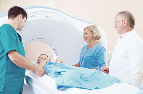 Elder woman, a Doctor and young male nurse standing by the girl before Computed Tomography examination.