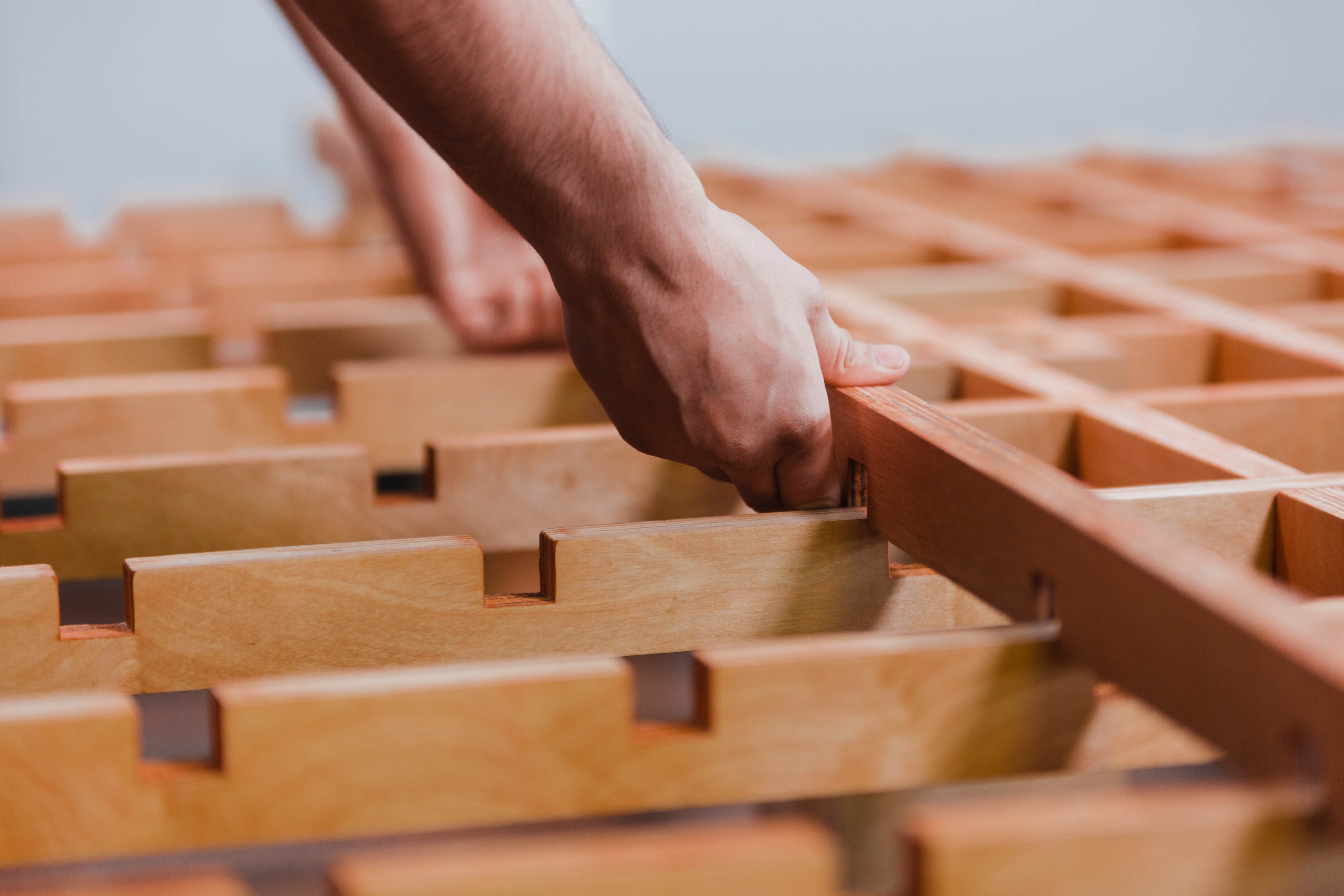 Man putting slat on Tic Tac Toe Bed Frame