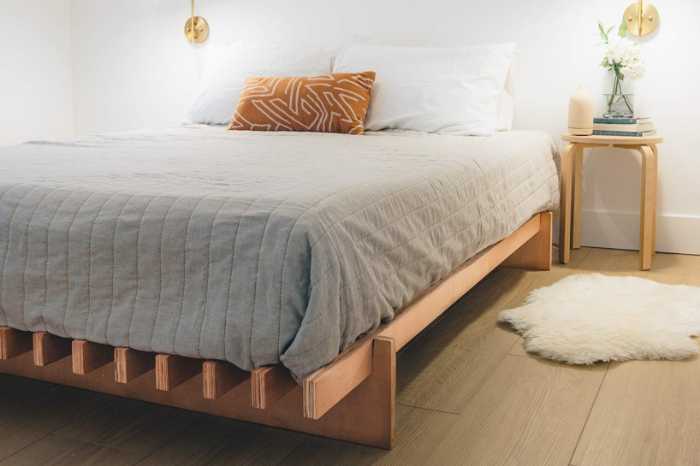 The No Fuss Plus bed frame from Quagga Designs with a mattress and bedding on top in a bright bedroom