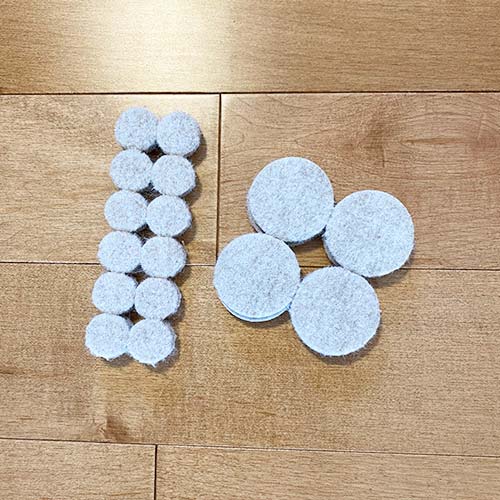 Some felt pads on a hardwood floor