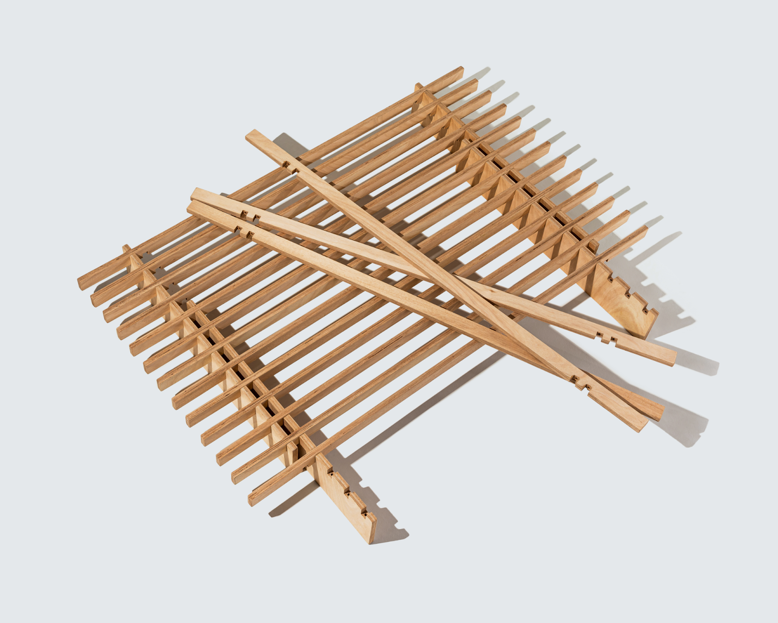 A No Fuss Plus wood bed frame from Quagga with some slats taken off and resting on its base.