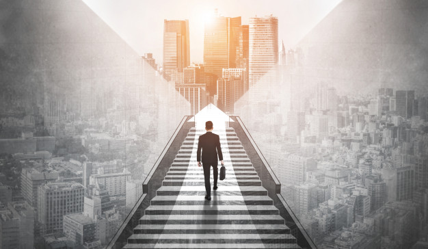 Ambitious business man climbing stairs to success. Premium Photo