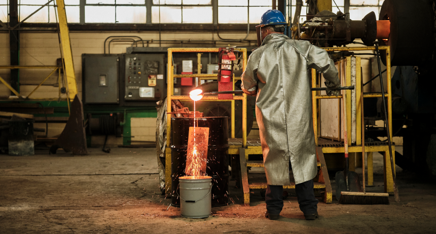 Candid portrait of a Sabin employee in protective heat gear working with molten metal.