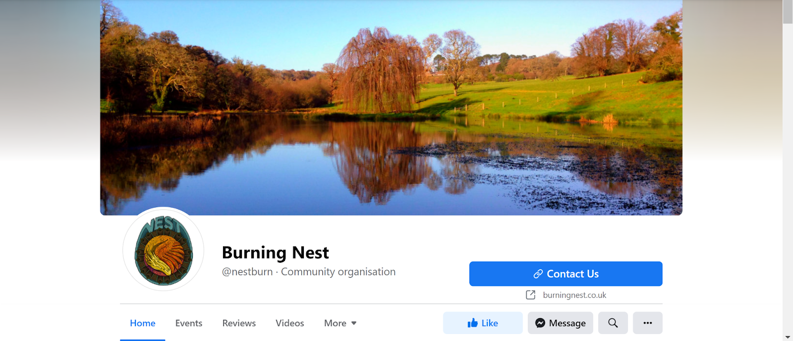 Screenshot of Burning Nest Facebook page with image of a lake and some trees