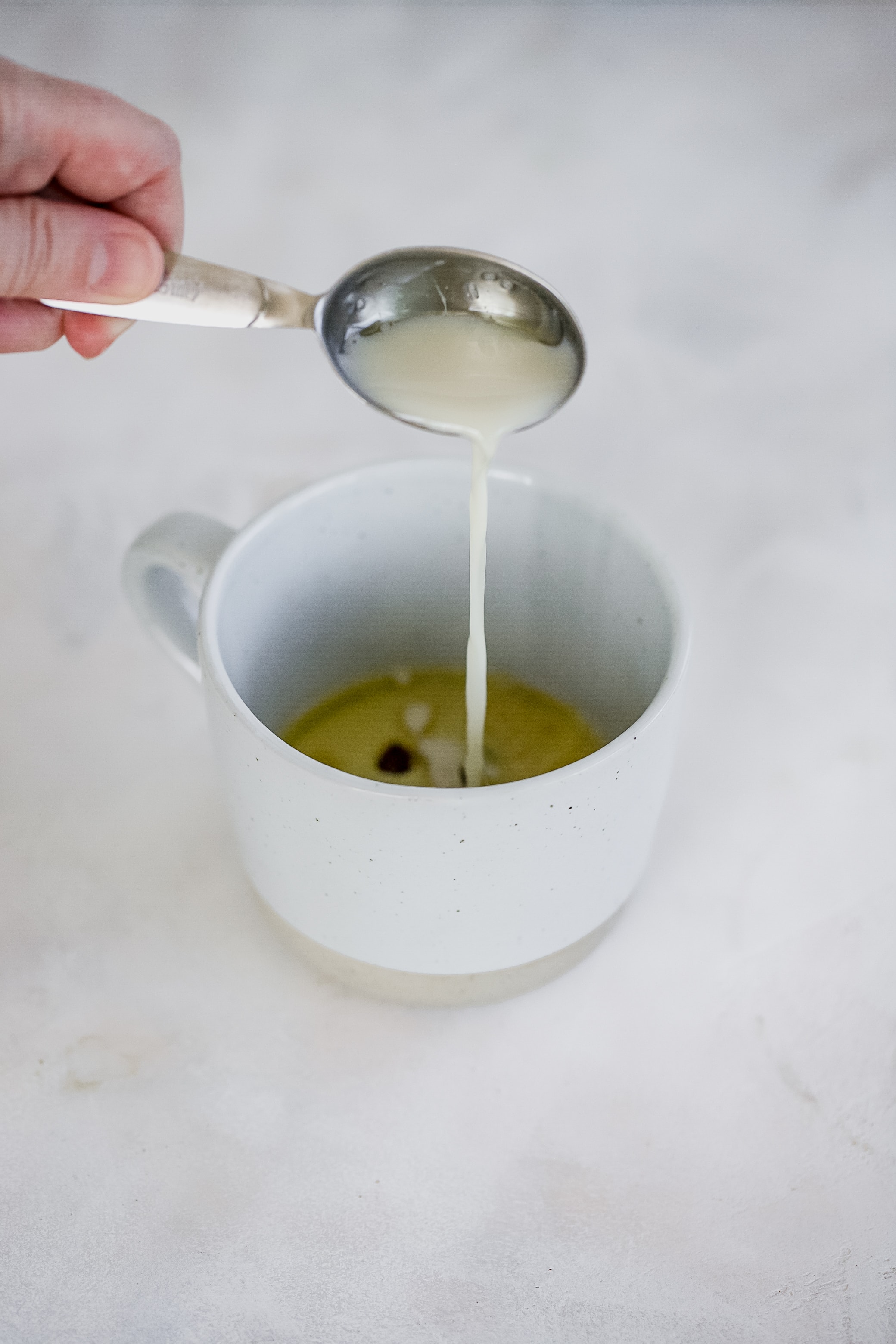 pouring milk into mug cake
