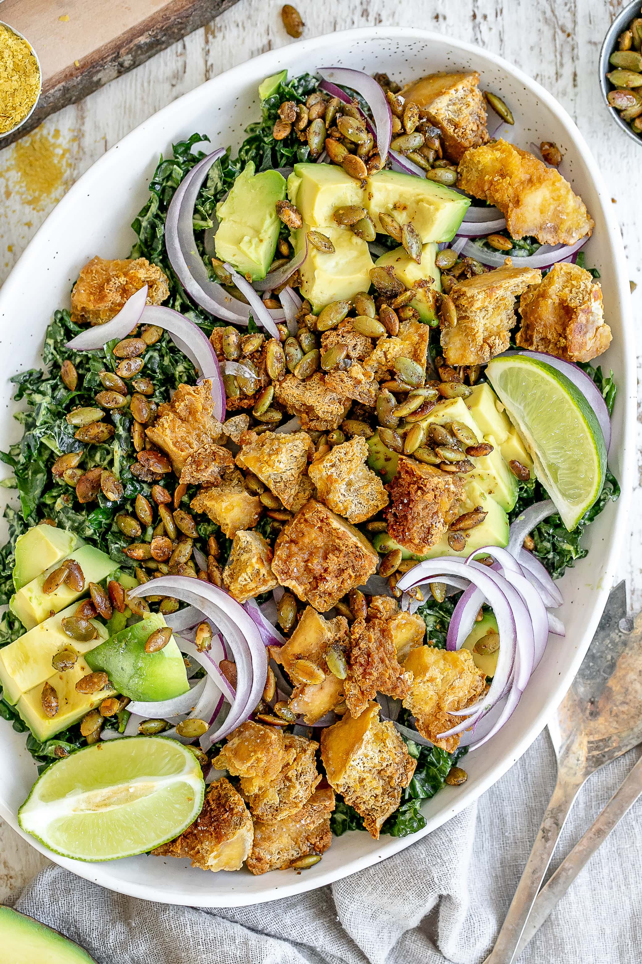 vegan kale salad on platter with tofu