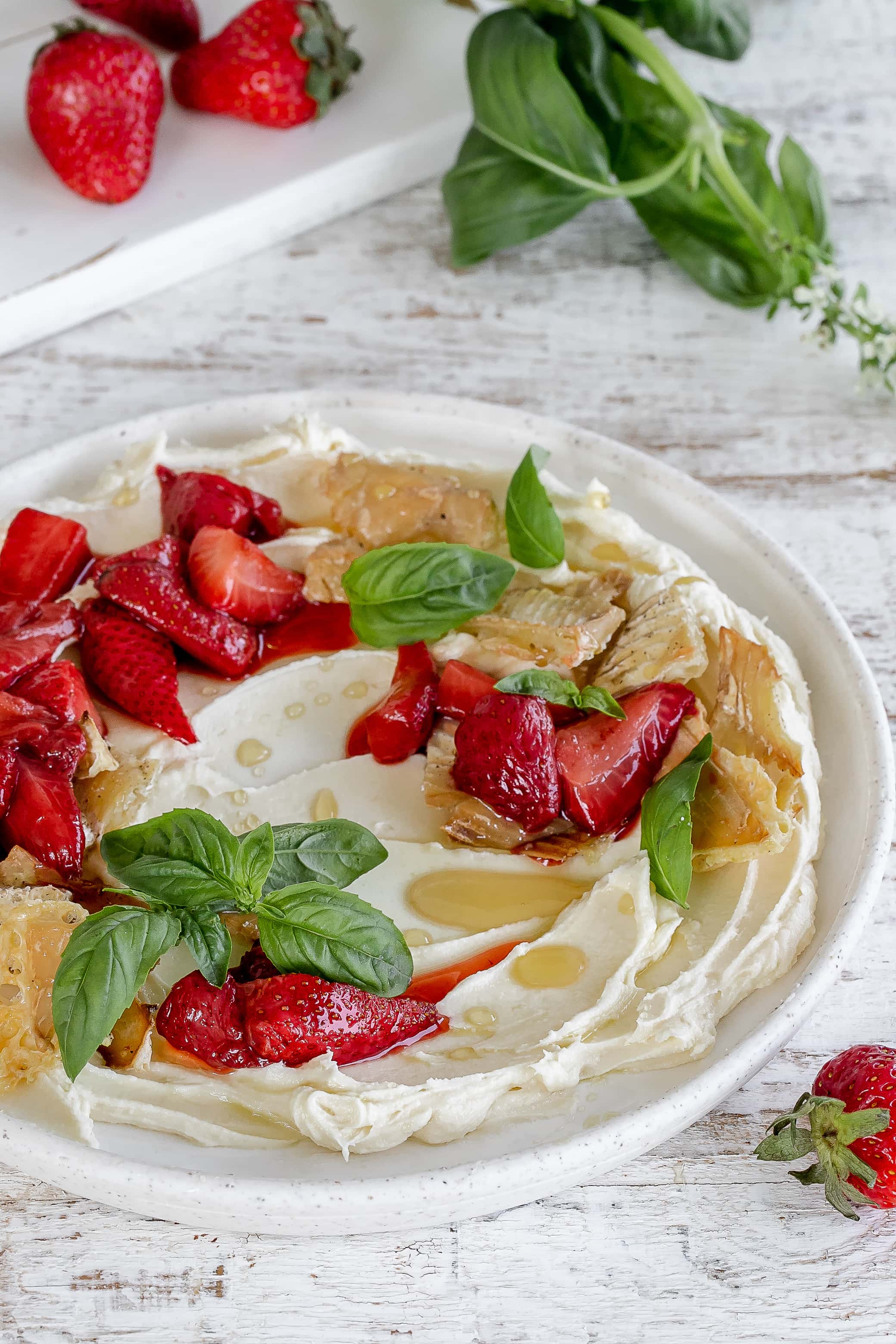 whipped brie on a plate with strawberries.