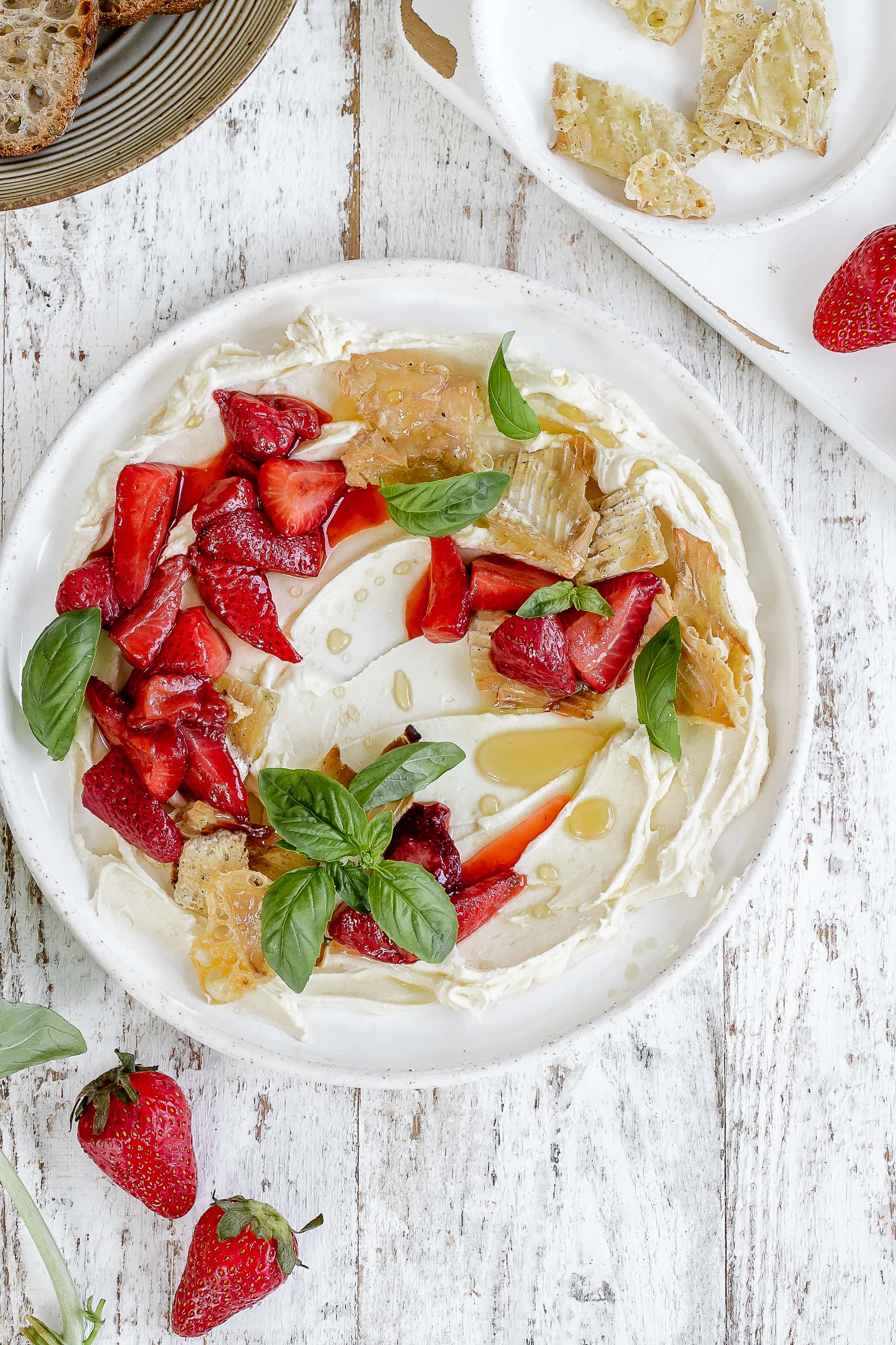 whipped brie on a plate with strawberries.