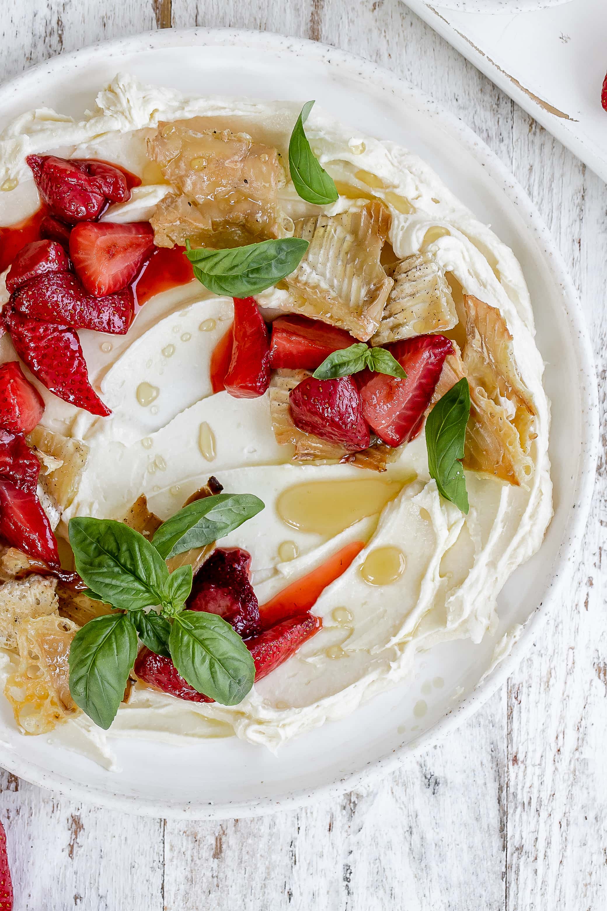 whipped brie on a plate with strawberries.