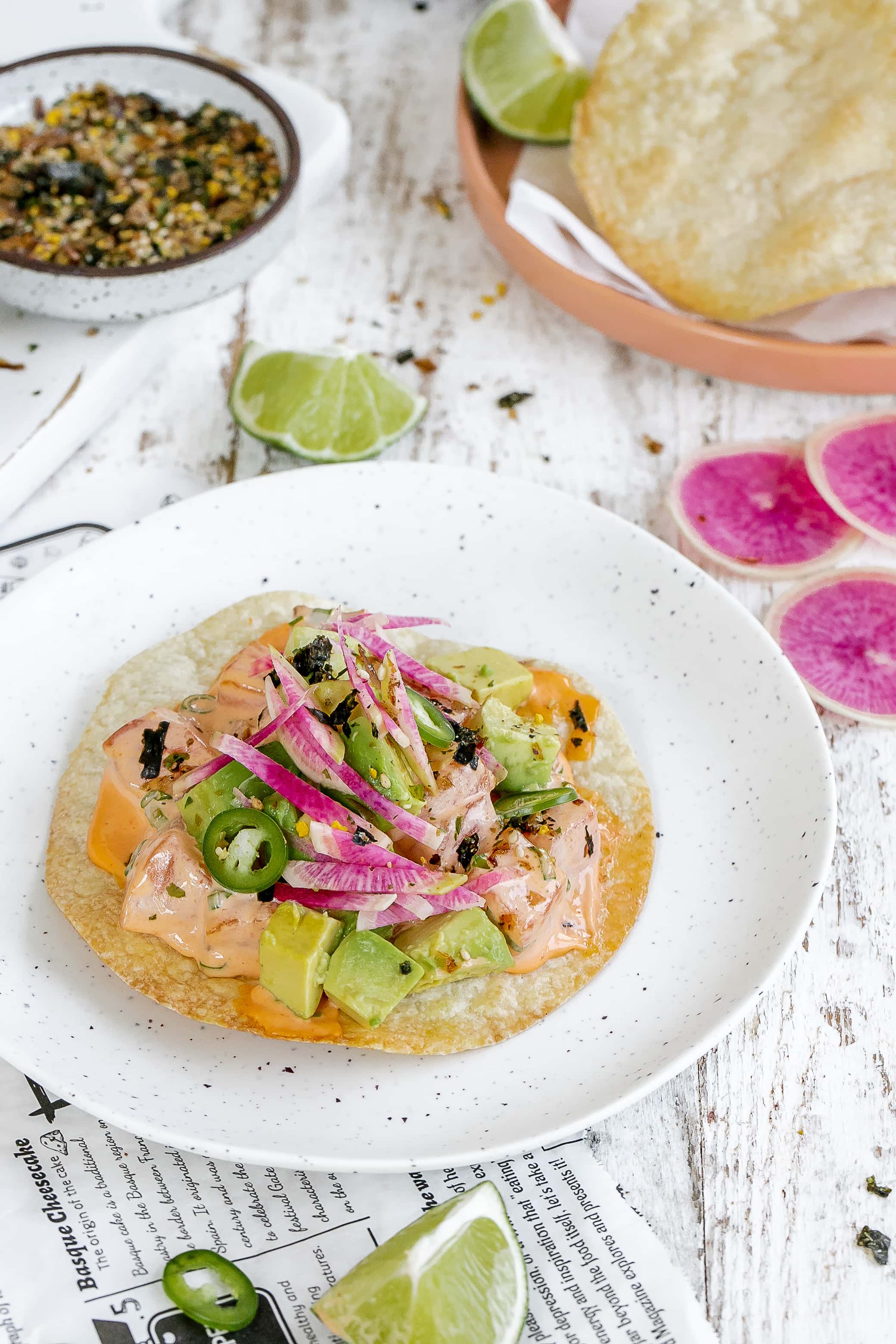 salmon tostadas on a plate with toppings.