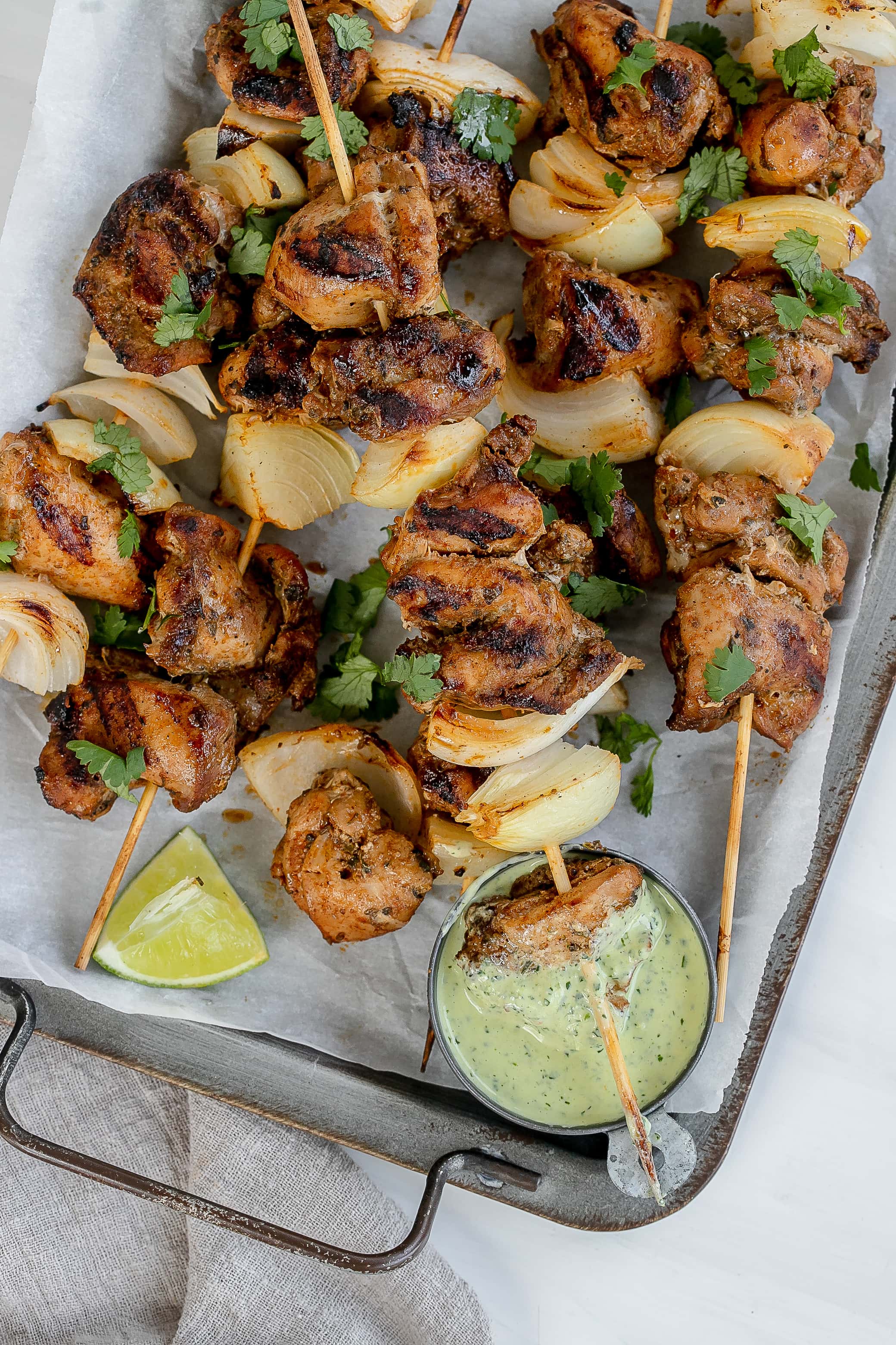 Peruvian chicken skewers with green sauce. 