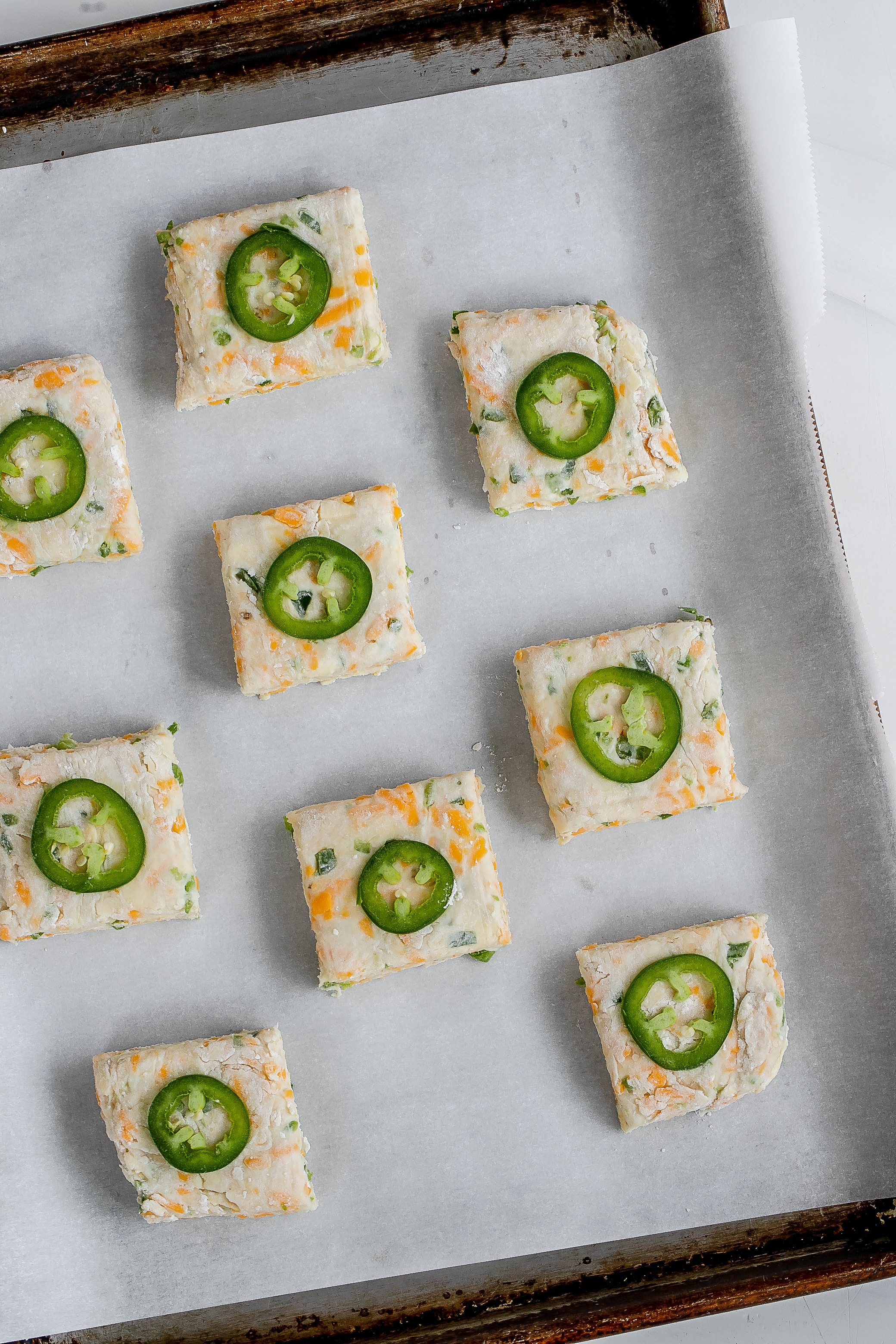 uncooked biscuits on baking sheet.