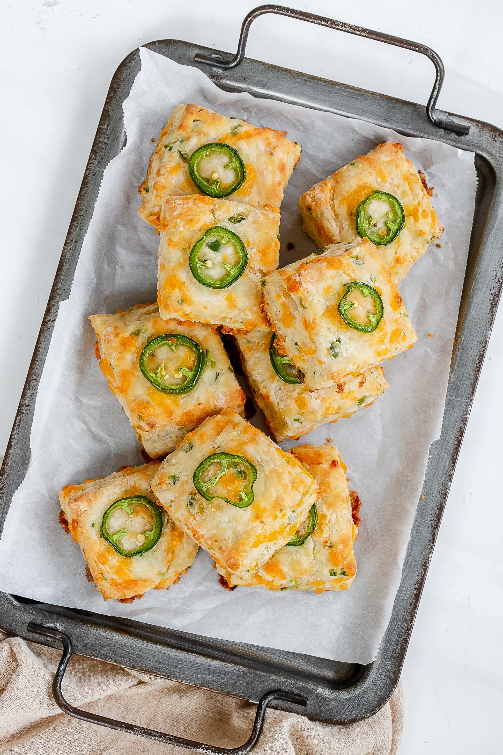 jalapeño cheddar biscuits on baking sheet.