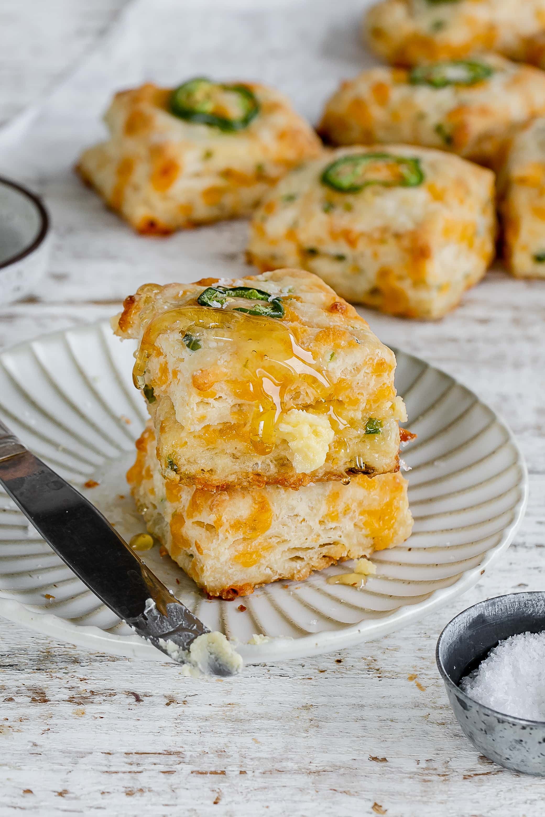 jalapeño cheddar biscuits with honey drizzling down.