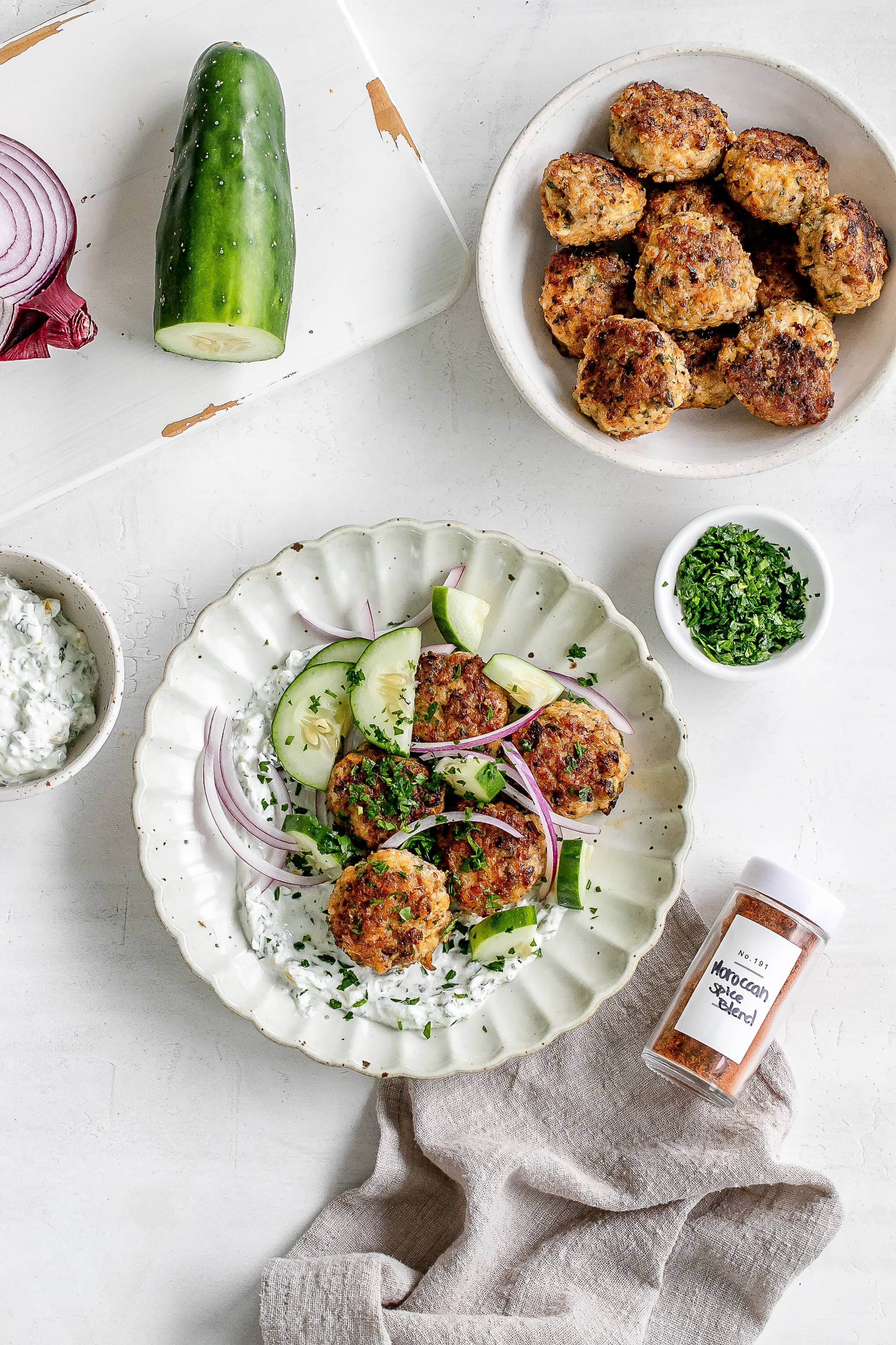 Moroccan chicken meatballs on a plate with yogurt dip.