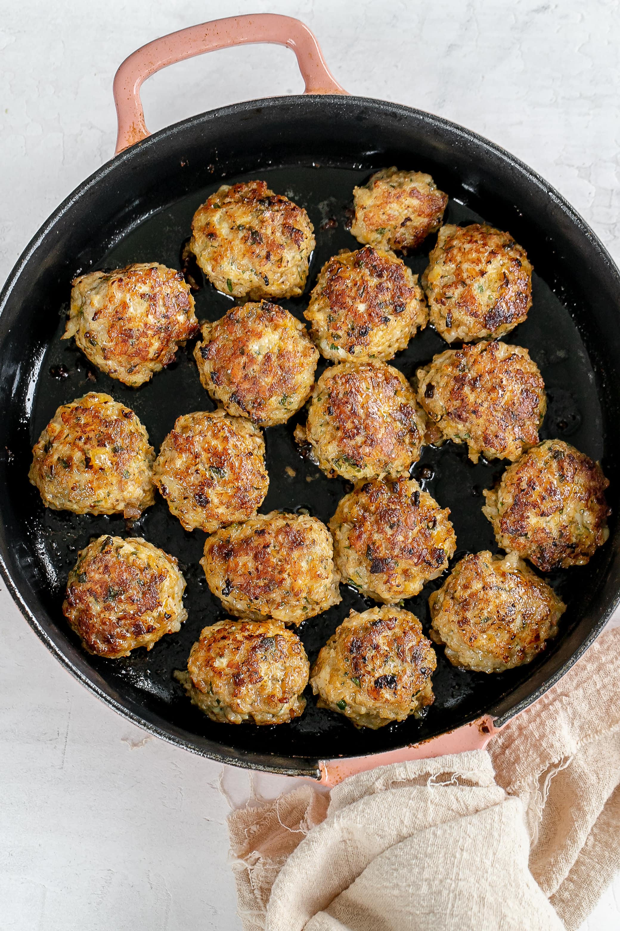 chicken meatballs in skillet cooked. 