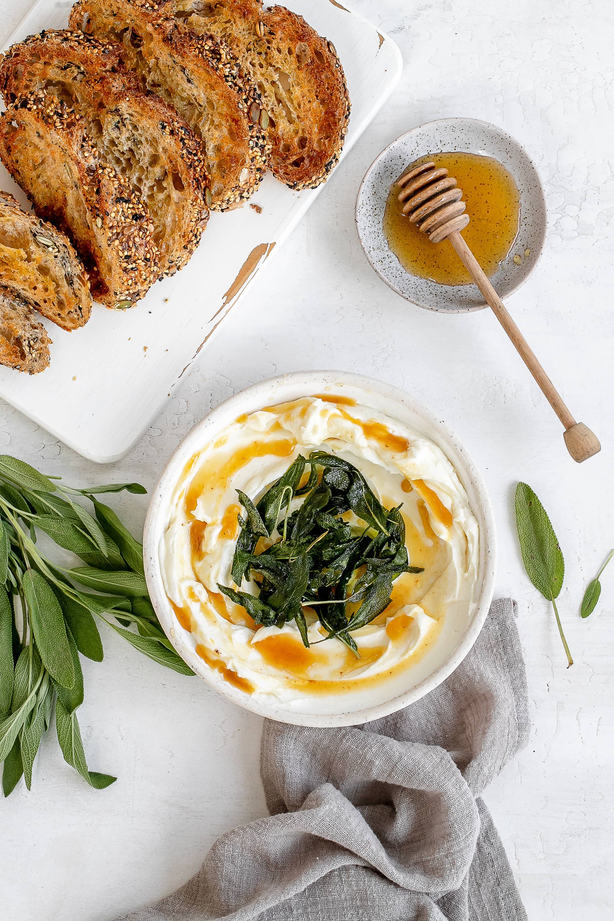 whipped ricotta in a bowl with butter and sage.