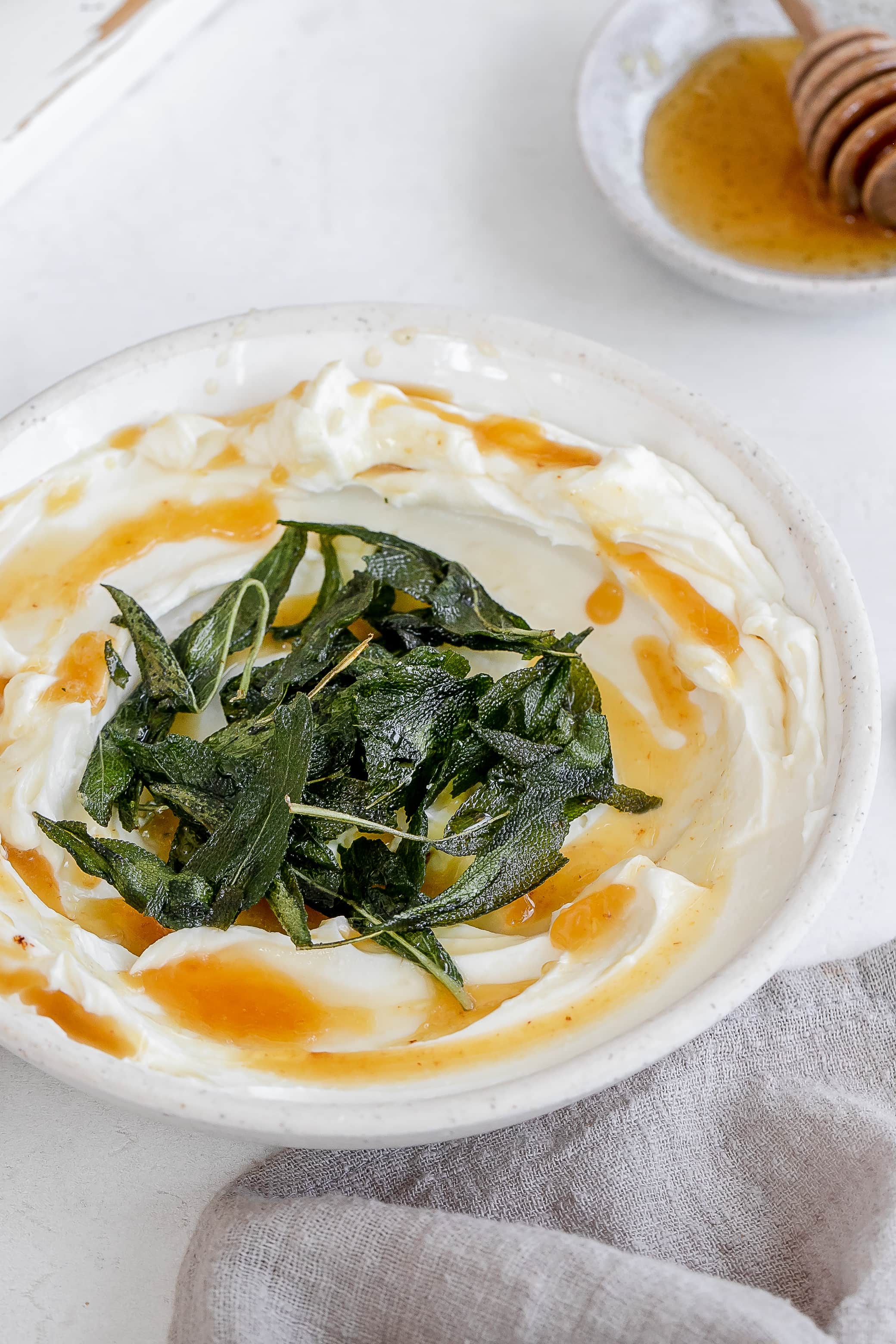 whipped ricotta in a bowl with butter and sage.