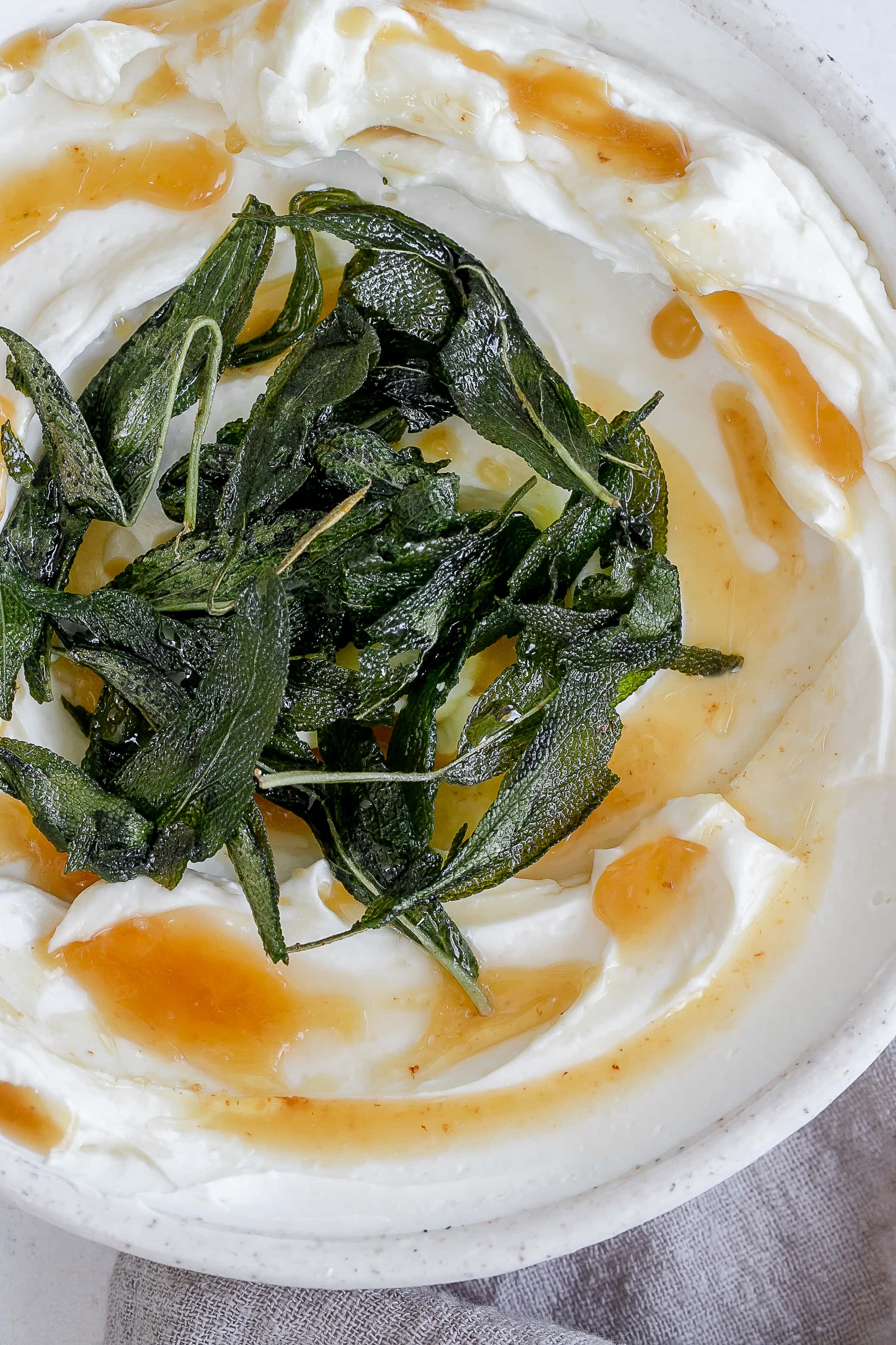 whipped ricotta in a bowl with butter and sage.