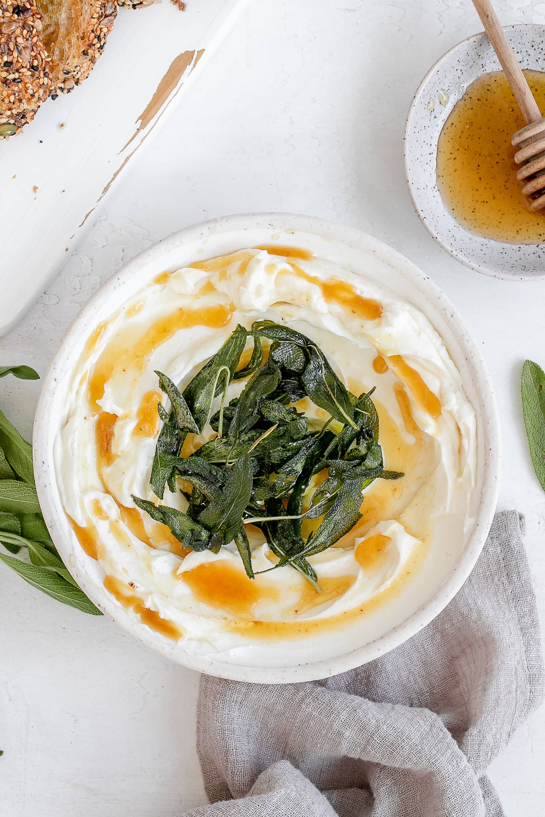 whipped ricotta in a bowl with butter and sage.