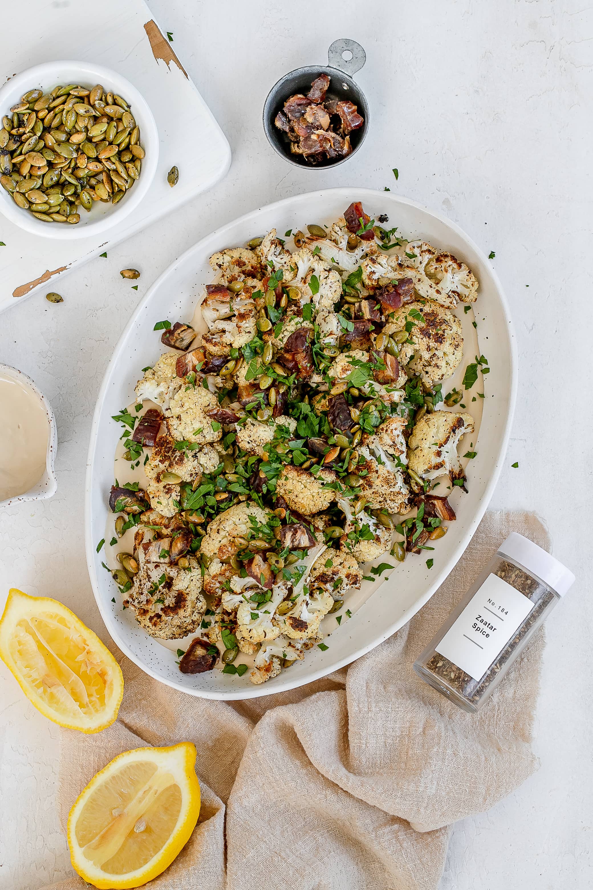 roasted cauliflower with tahini  on a platter. 