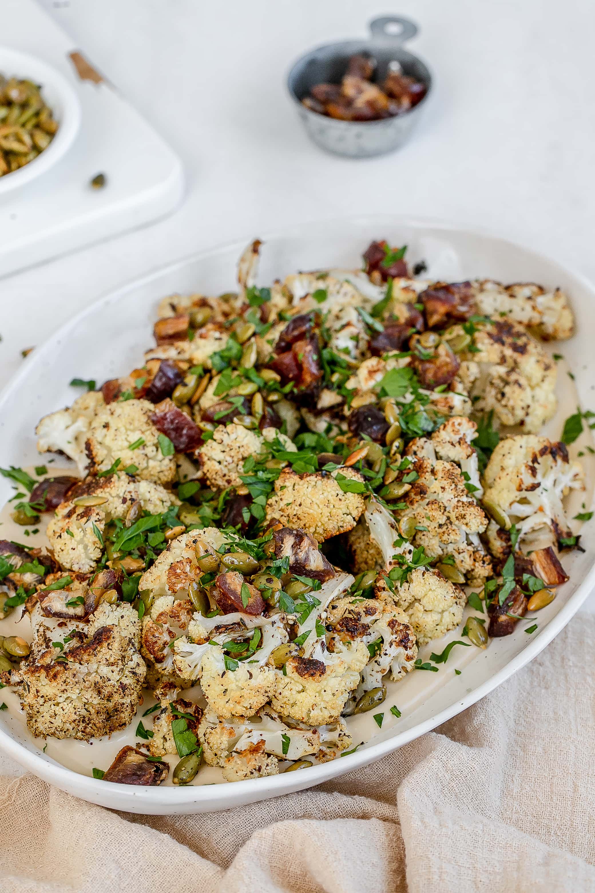 roasted cauliflower with tahini on a platter. 