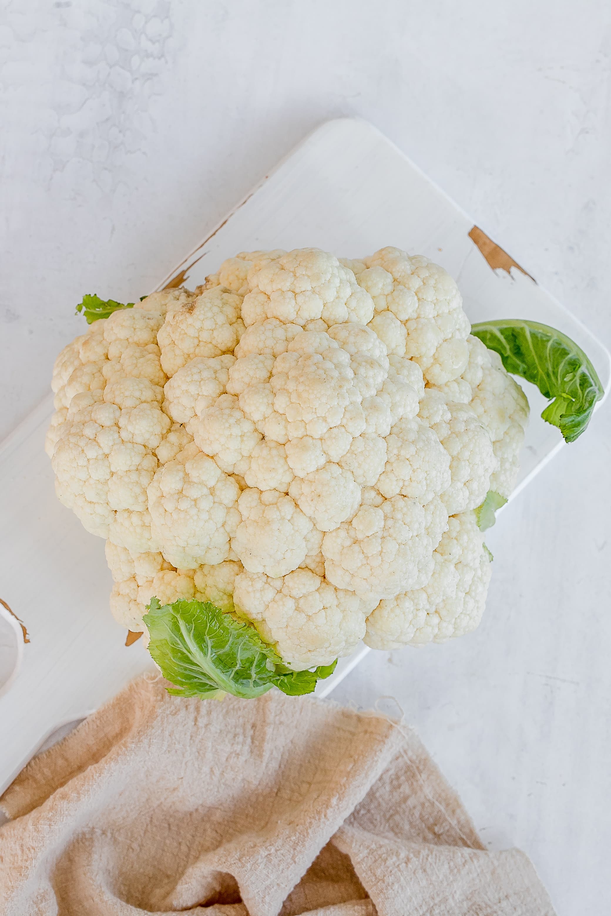 cauliflower on a cutting board.