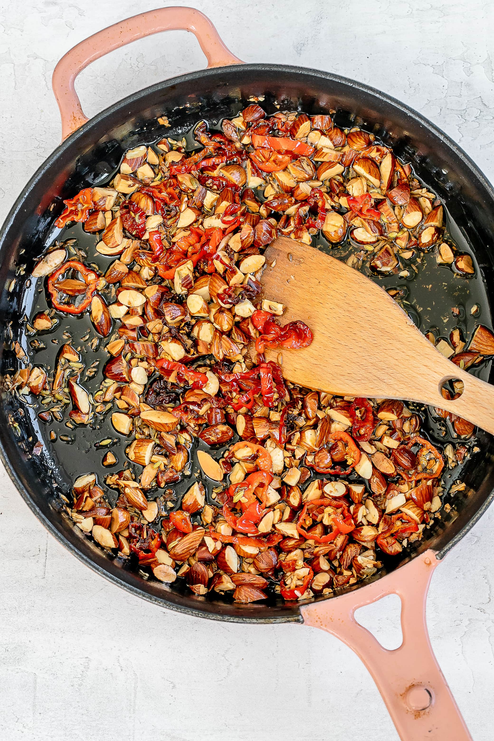 almonds and oil in skillet with spices.