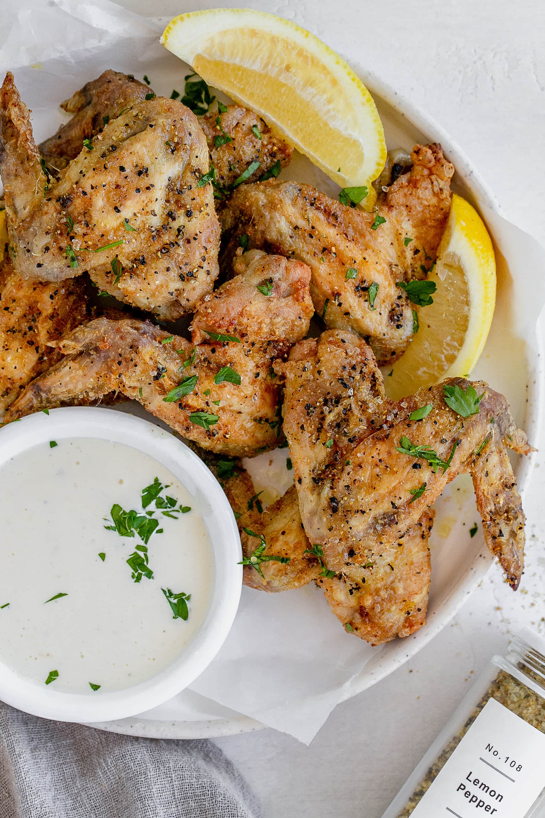 air fryer lemon pepper chicken wings on a plate.