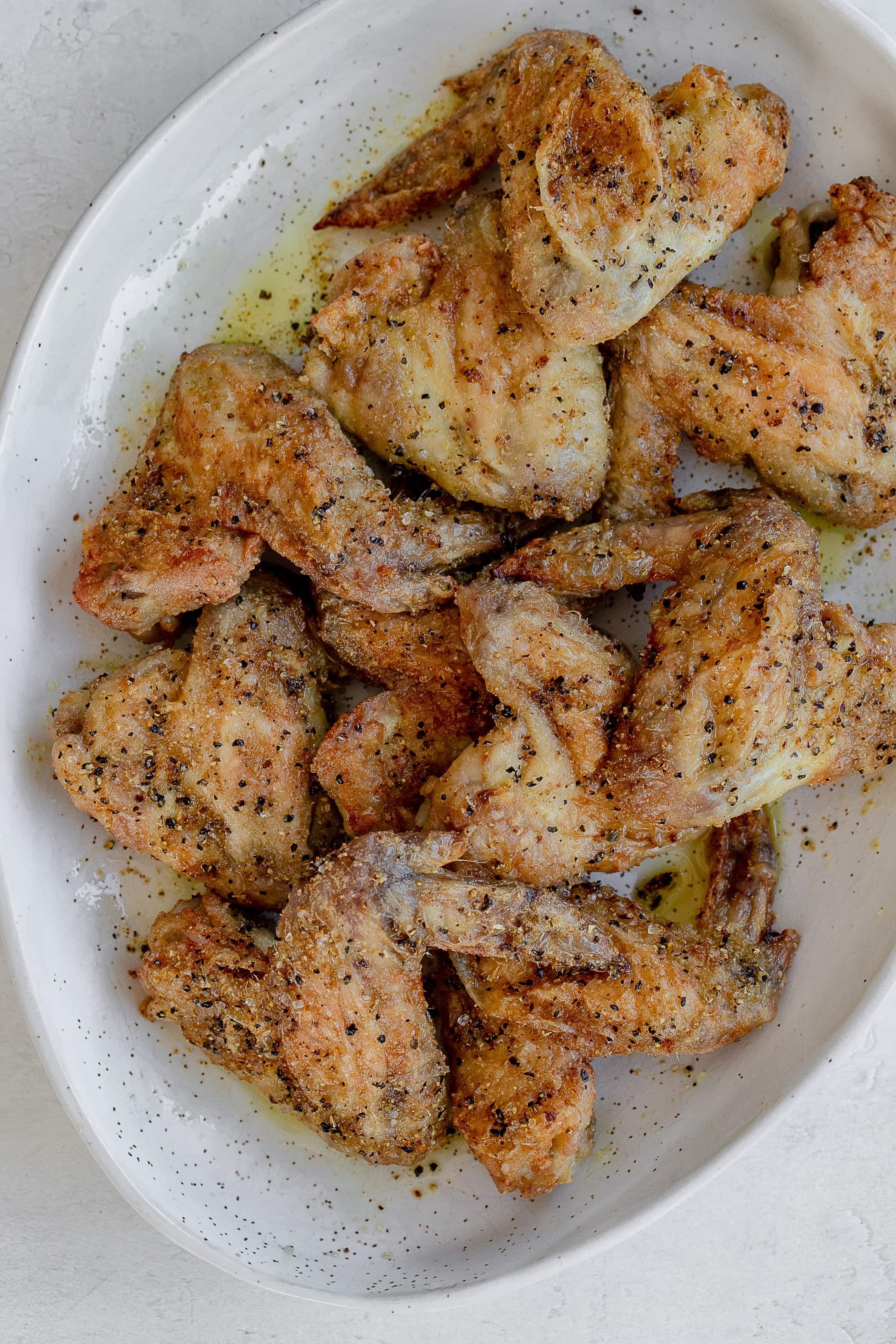 air fryer lemon pepper chicken wings on a platter.