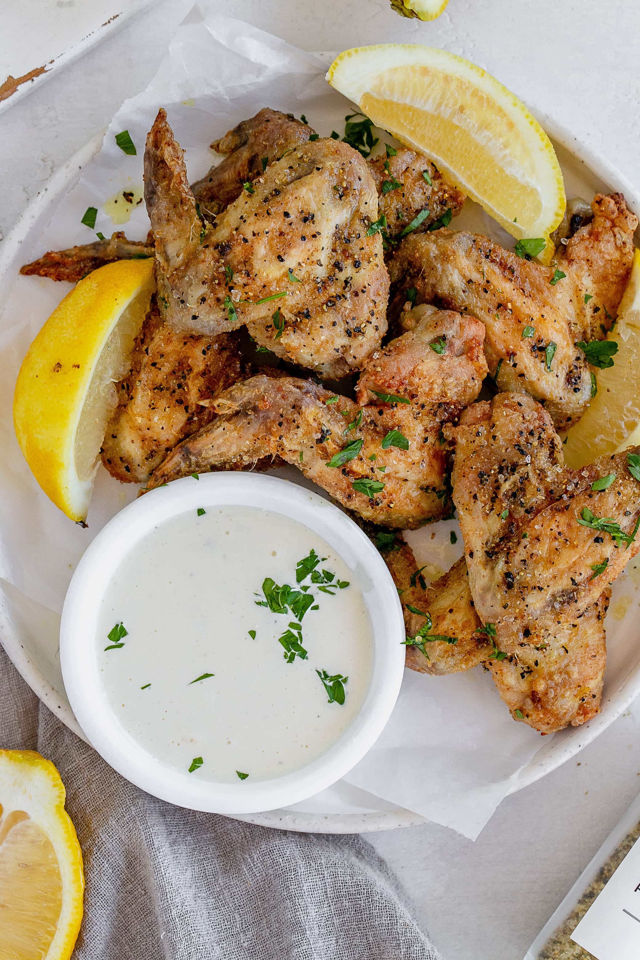 air fryer lemon pepper chicken wings on a plate.