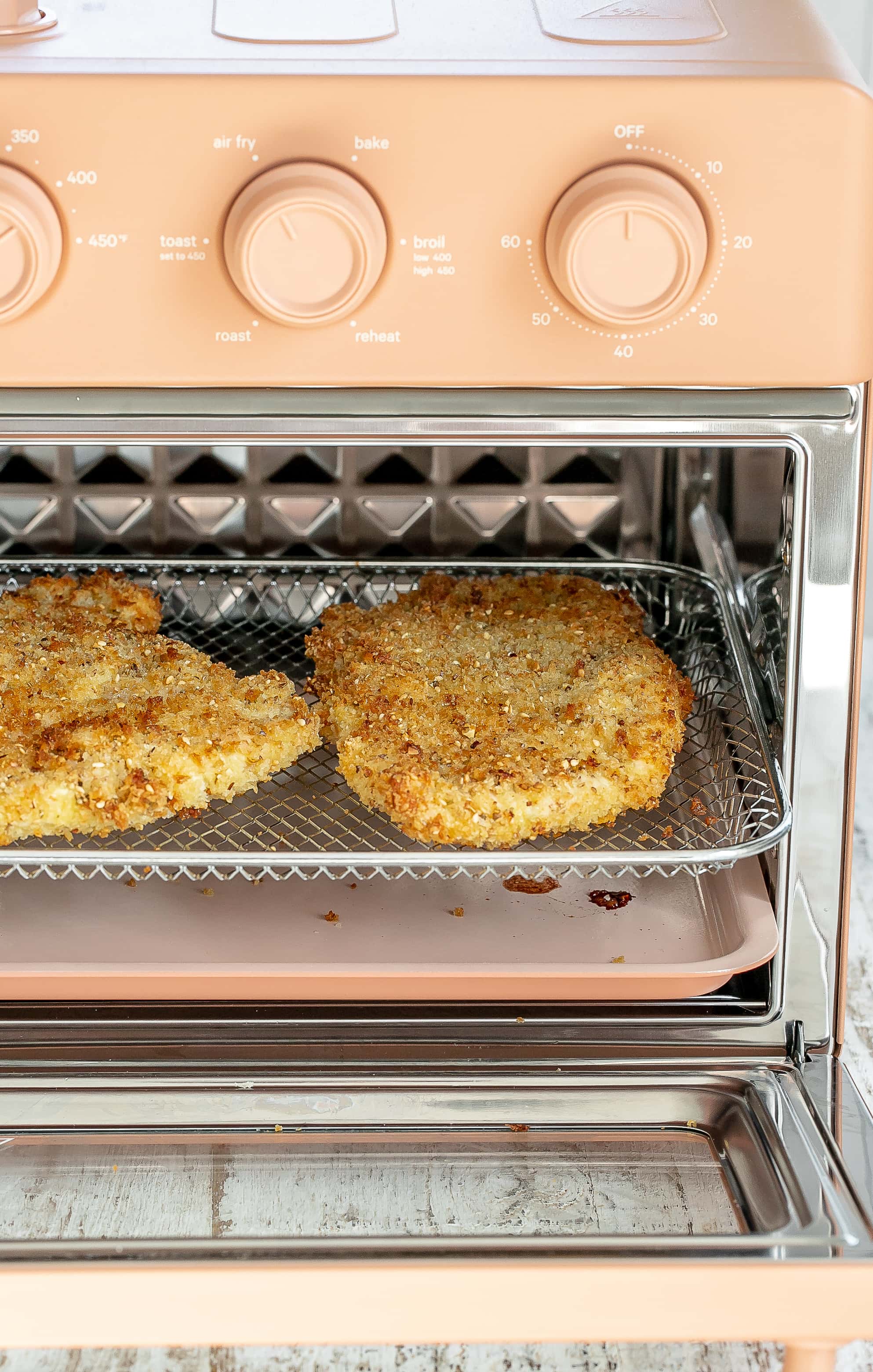 air fryer with chicken inside.  