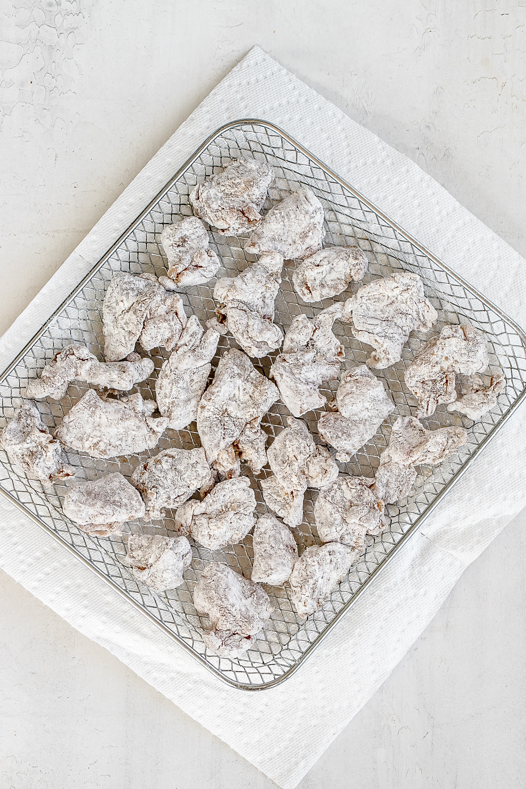 chicken pieces coated in the air fryer basket