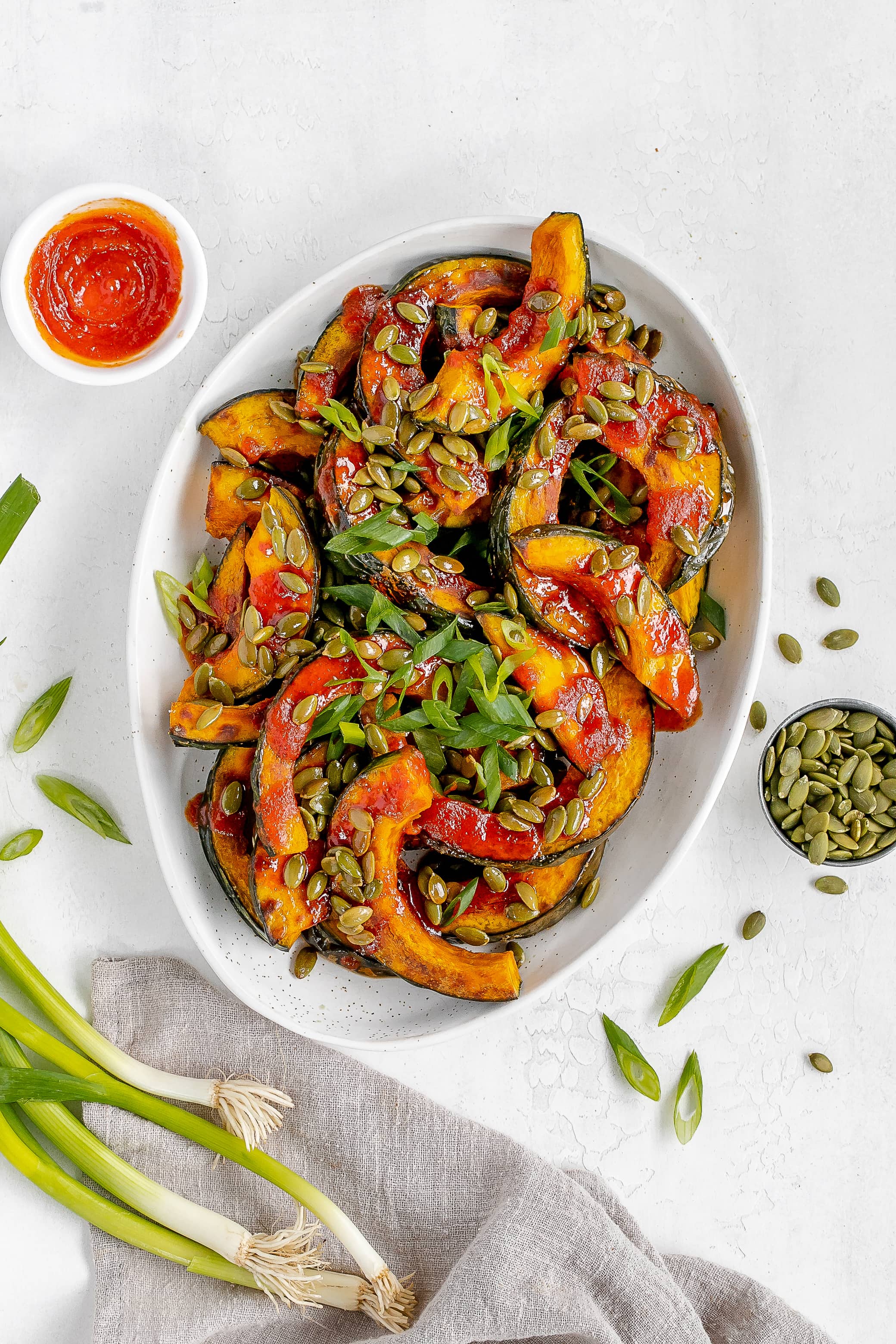 gochujang squash on a platter with toppings. 