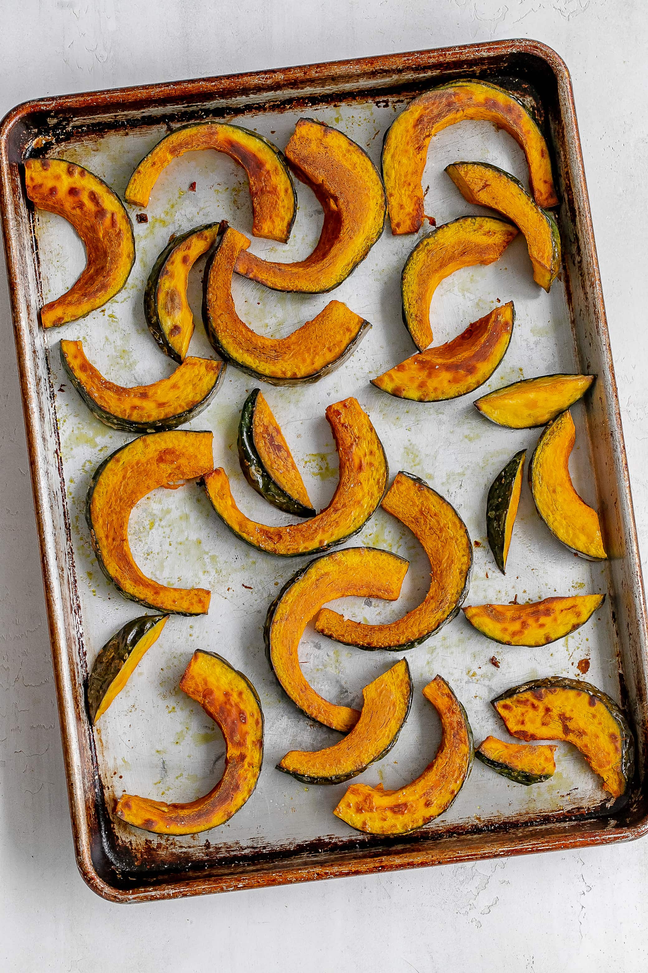roasted kabocha slices on baking sheet.