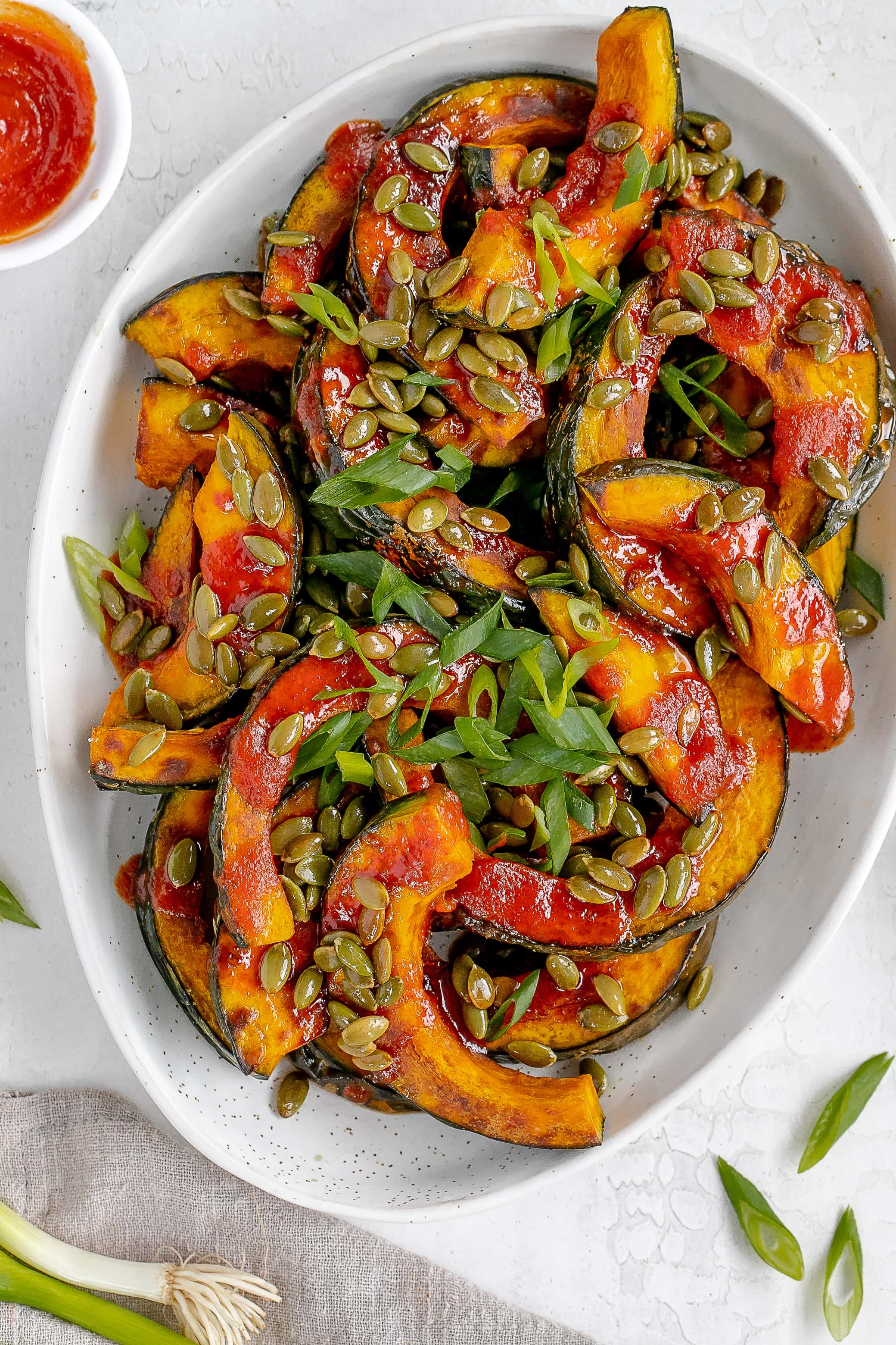 gochujang squash on a platter with toppings. 