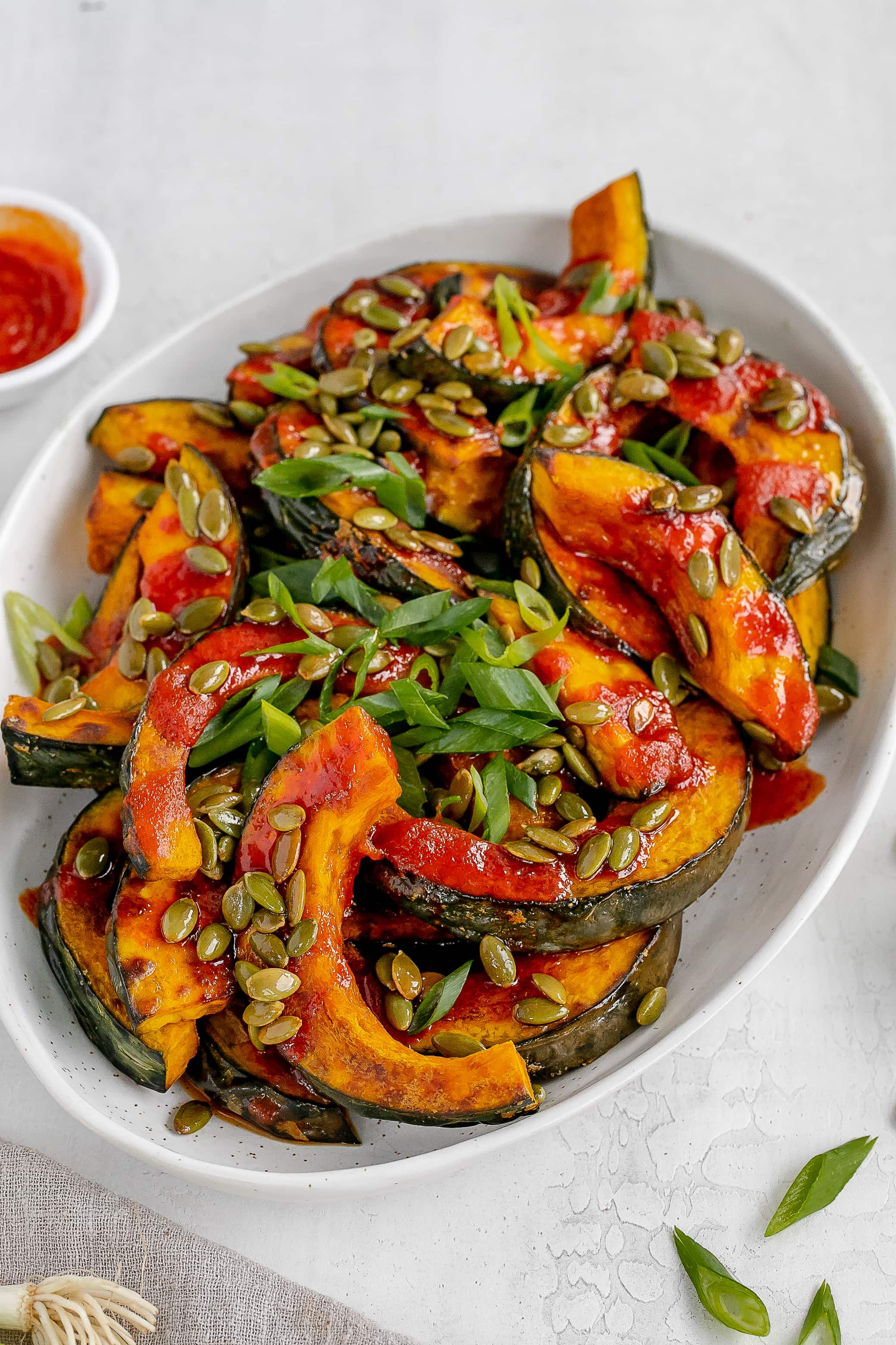 gochujang squash on a platter with toppings. 