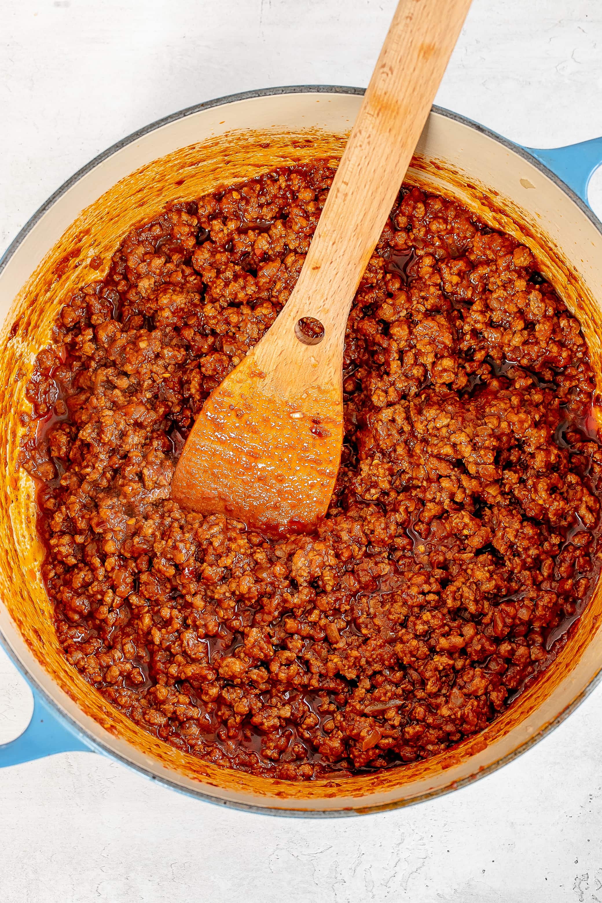 ground beef in dutch oven cooked with tomato paste.