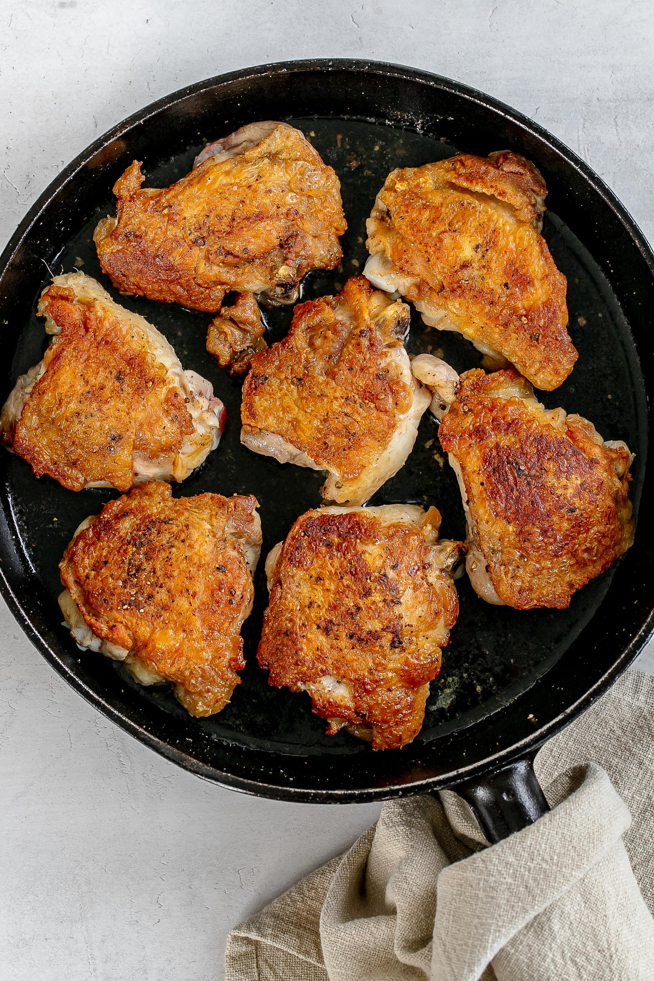 chicken thighs bone in, skin on in cast iron skillet.