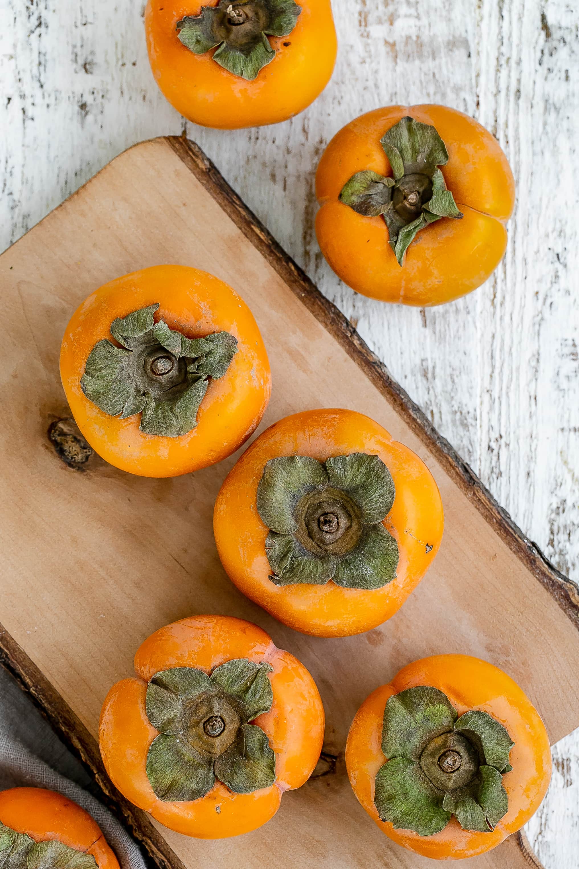 persimmons on a cutting board.