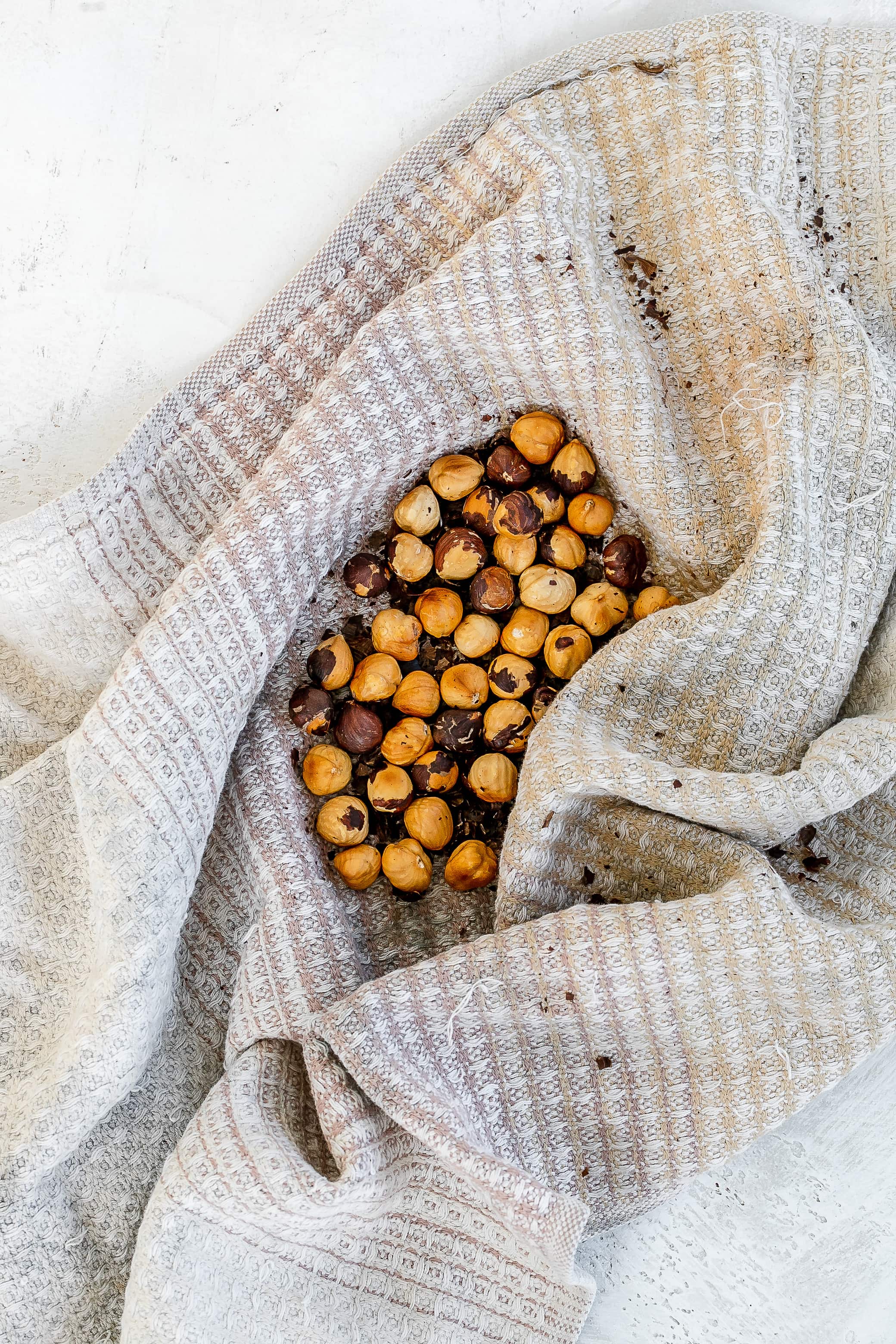 toasted hazelnuts on a kitchen towel.