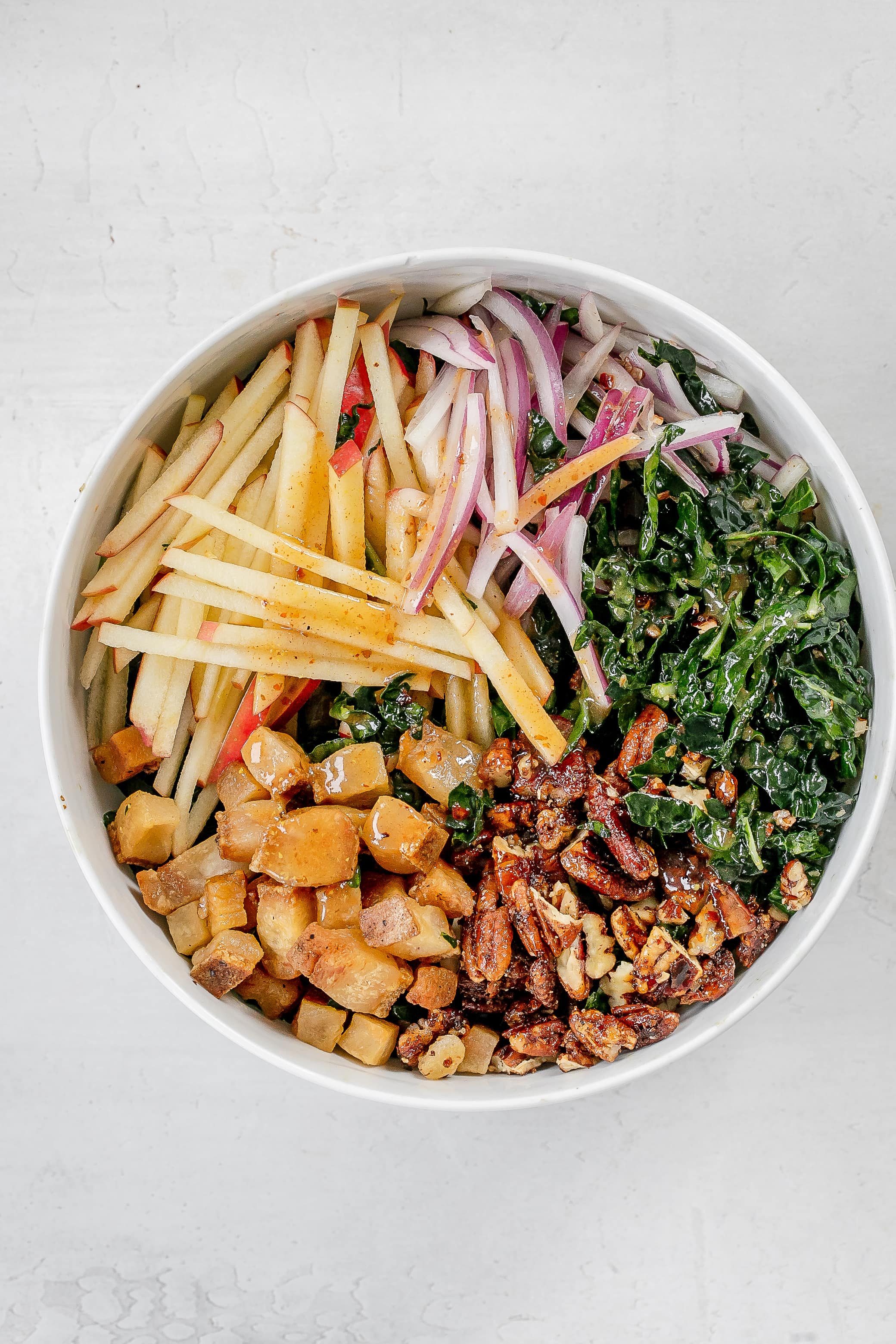 fall kale salad in a large salad bowl. 